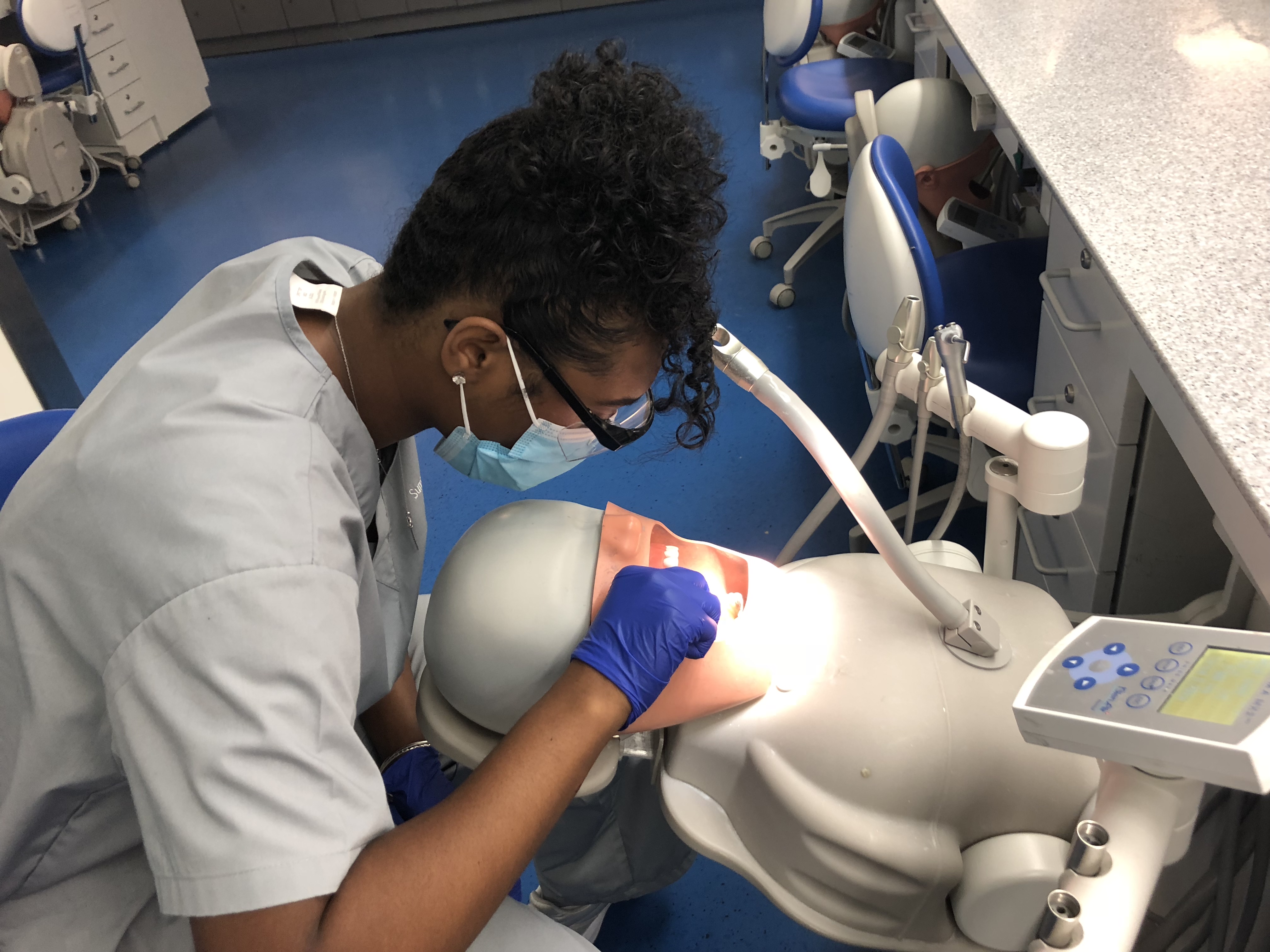 High school student learns dentistry in a simulation lab