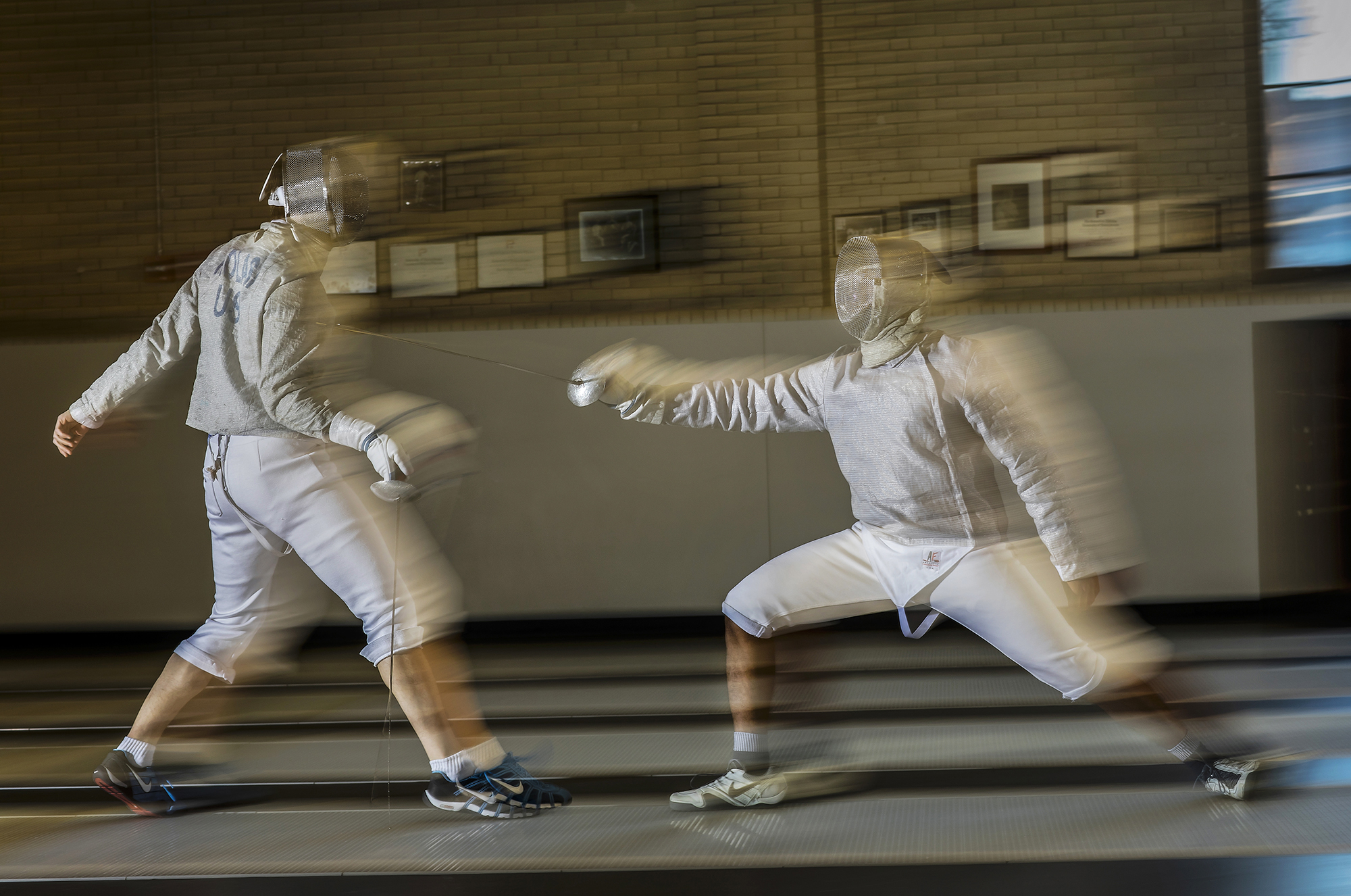 Julian Merchant, right, practices fencing with a teammate in Hutchinson Gym.