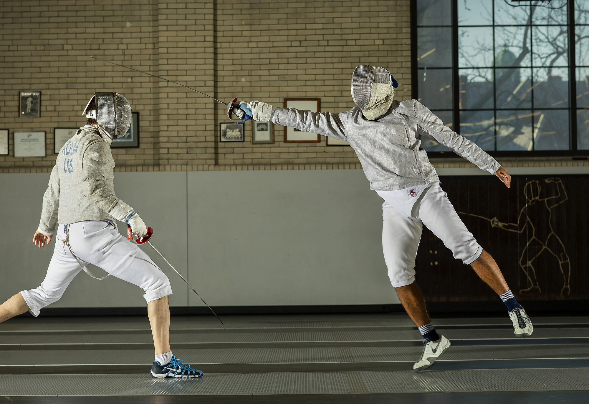 Fencer Julian Merchant practices with a teammate in Hutchinson Gym.