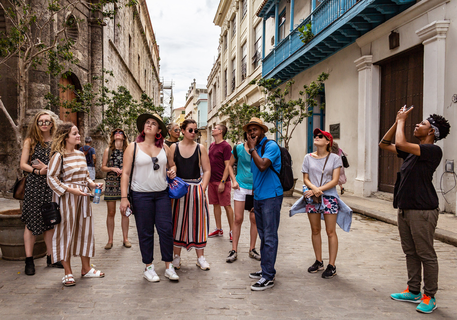 Students in street in Havana, Cuba looking at the historic buildings. 