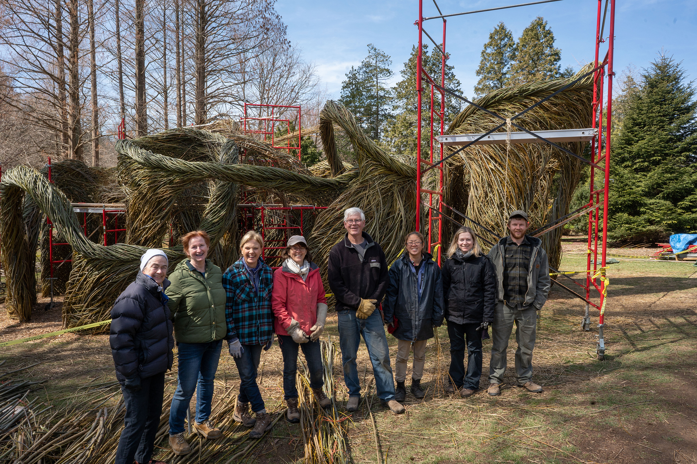 Patrick Dougherty with teammates and a work-in-progress sculpture
