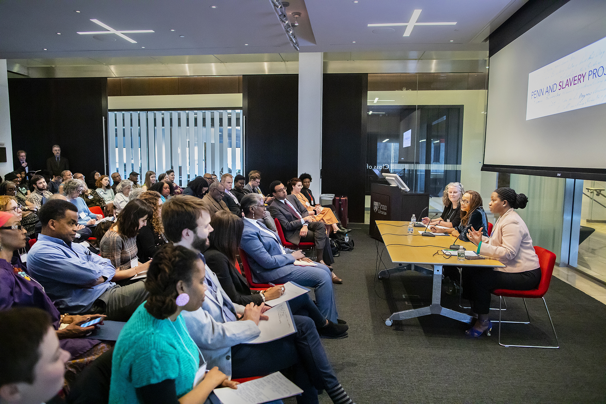 Professors speaking to a conference