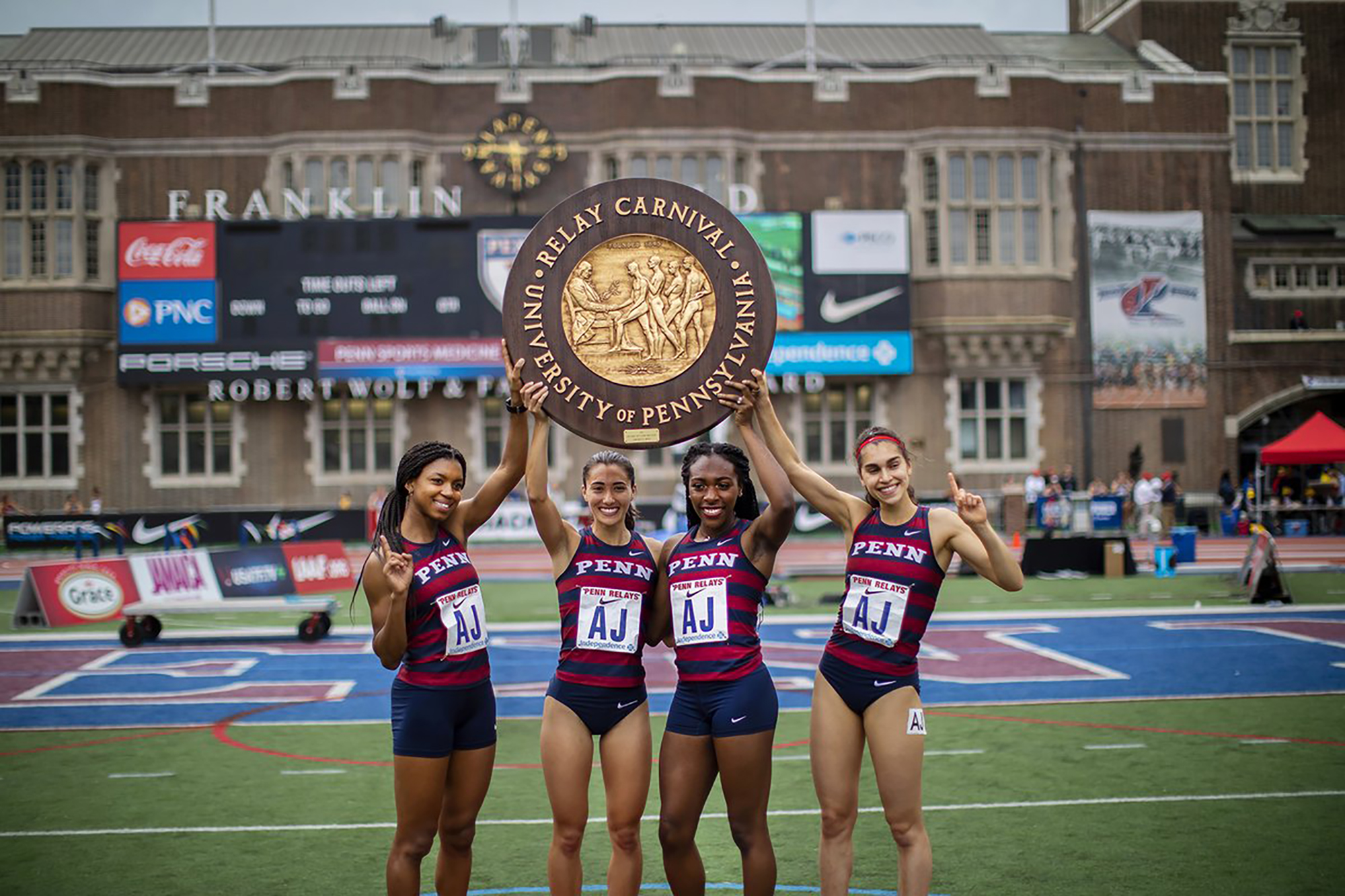 Nia Akins and her teammates hold up the award after winning the College Women’s Championship of America Distance Medley Relay. 
