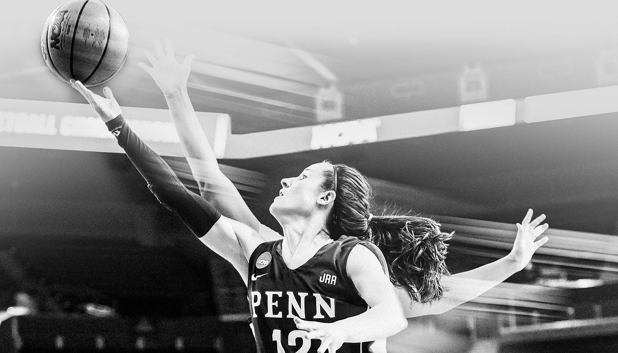 A women's basketball player shoots a shoot in a black and white photo for the Game Onward campaign.