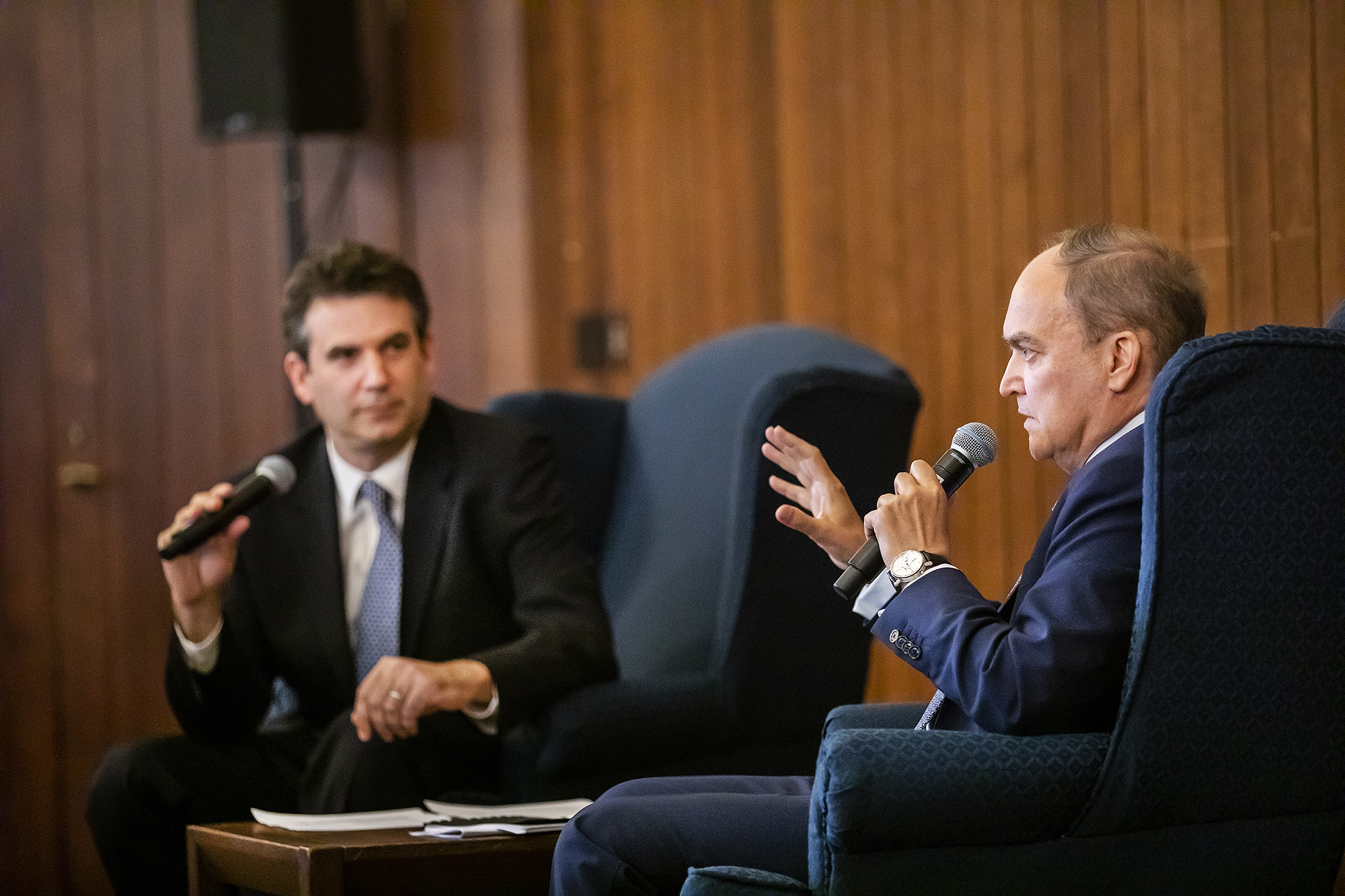 Two men sitting with microphones