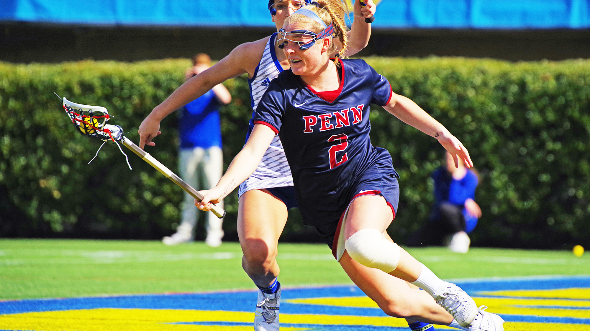 Midfielder Erin Barry makes a move with the ball in stick during a game.