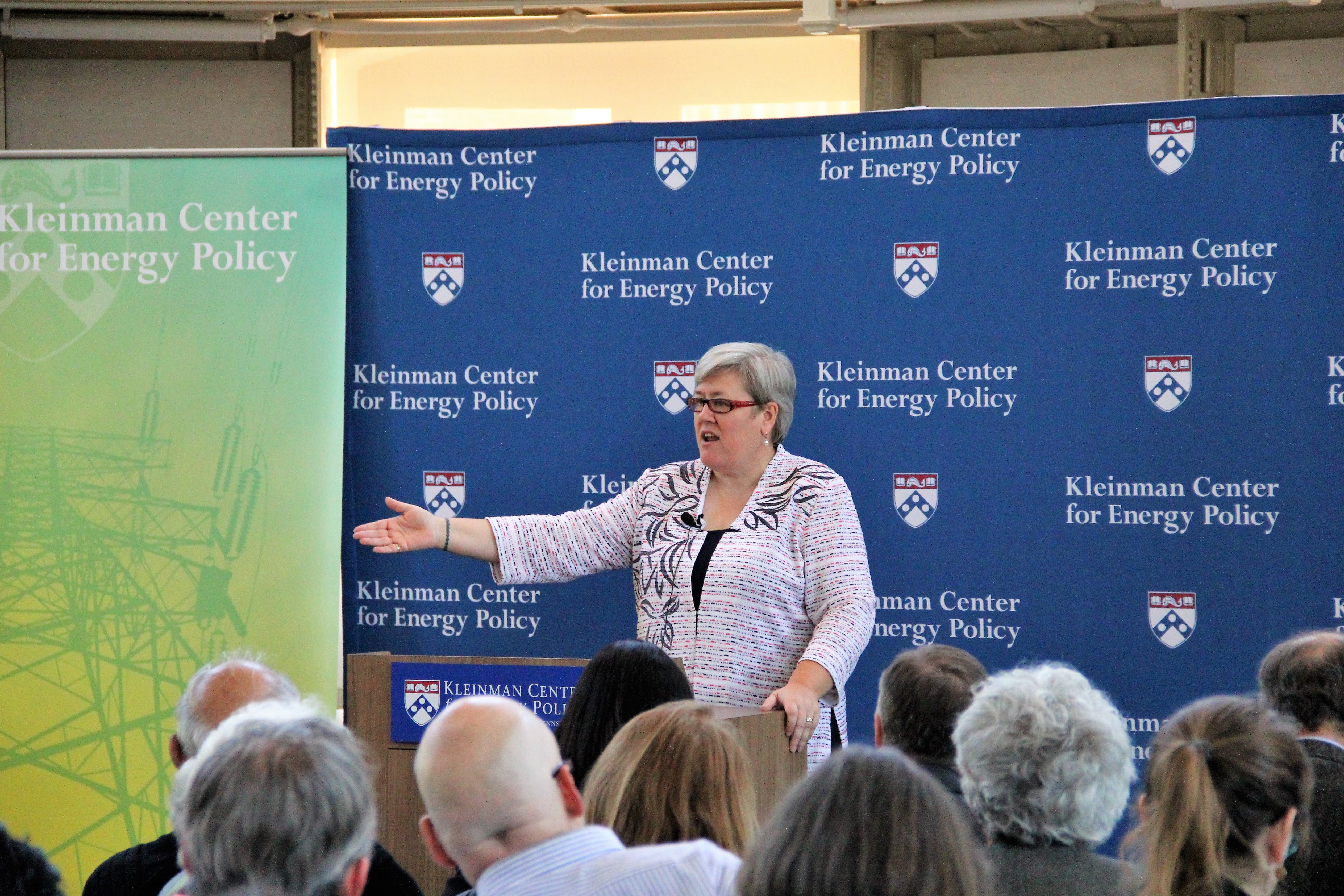 Rachel Kyte stands at a podium speaking, the sign on the podium reads "Kleinman Center for Energy Policy."