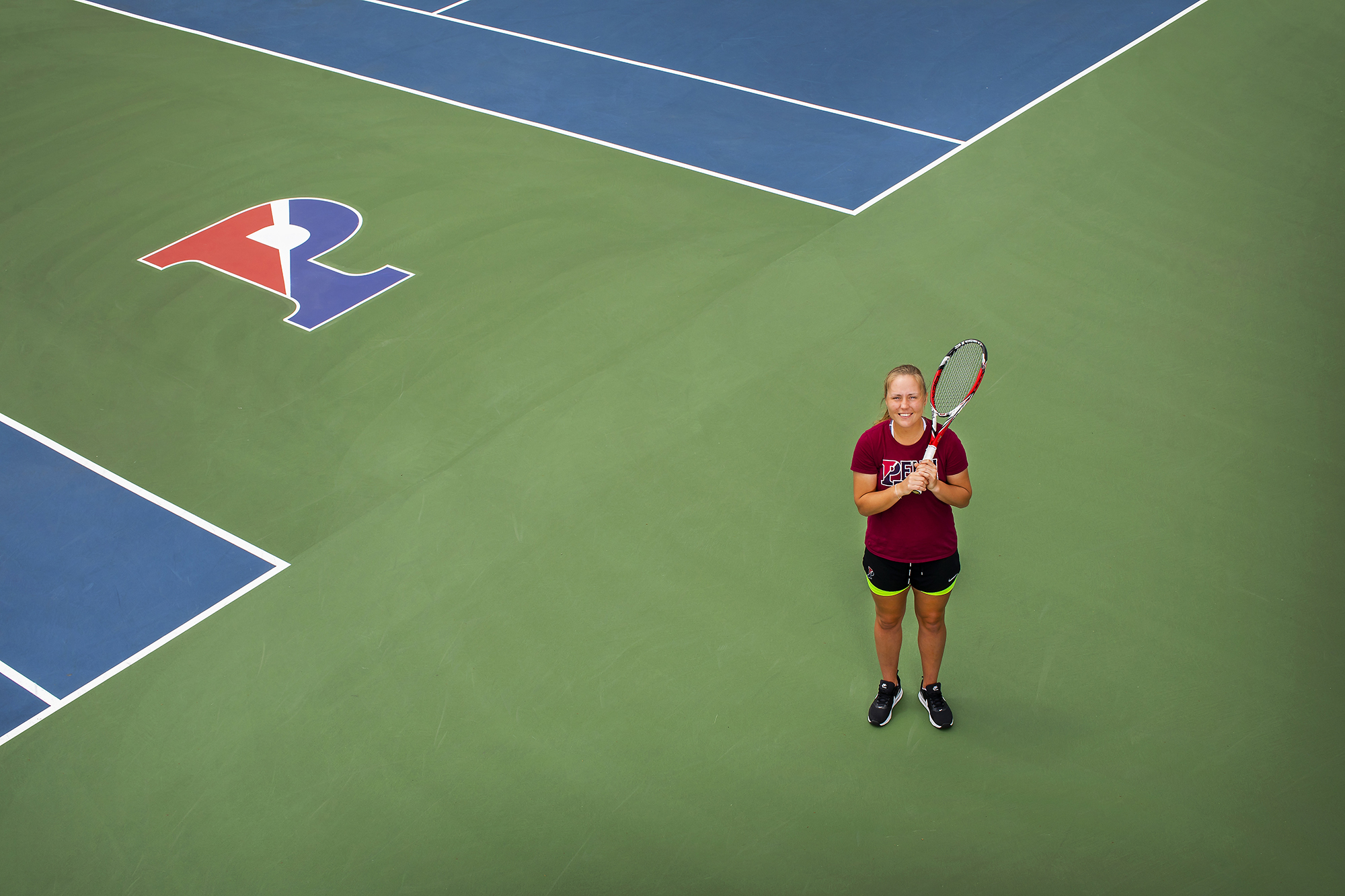 Iuliia Bryzgalova poses with her racket on the tennis courts at Penn Park.