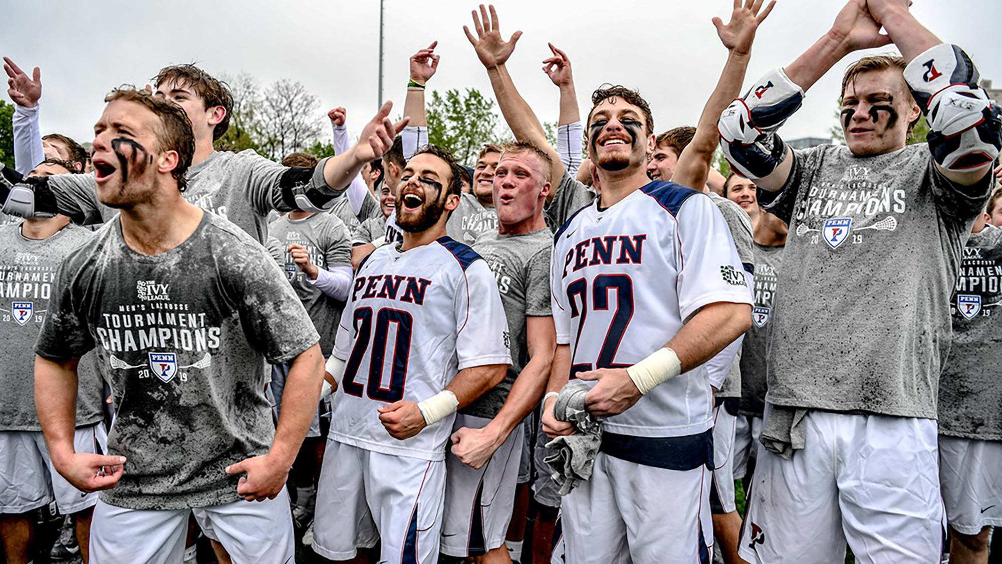 Penn men's lacrosse players celebrate after beating Yale in Ivy tourney final.