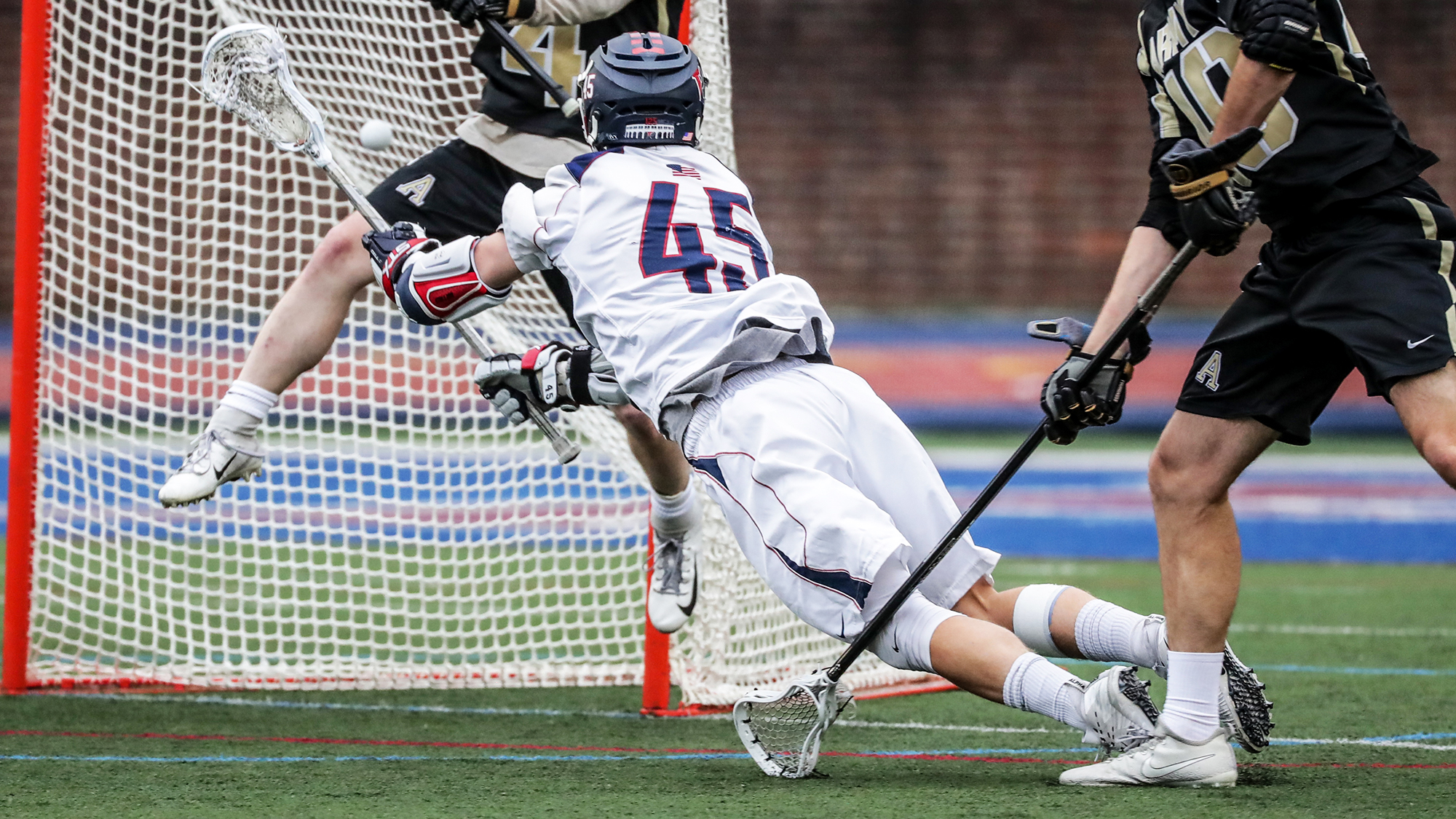 Simon Mathias shoots the ball in the next against Army at Franklin Field during an NCAA first round game.