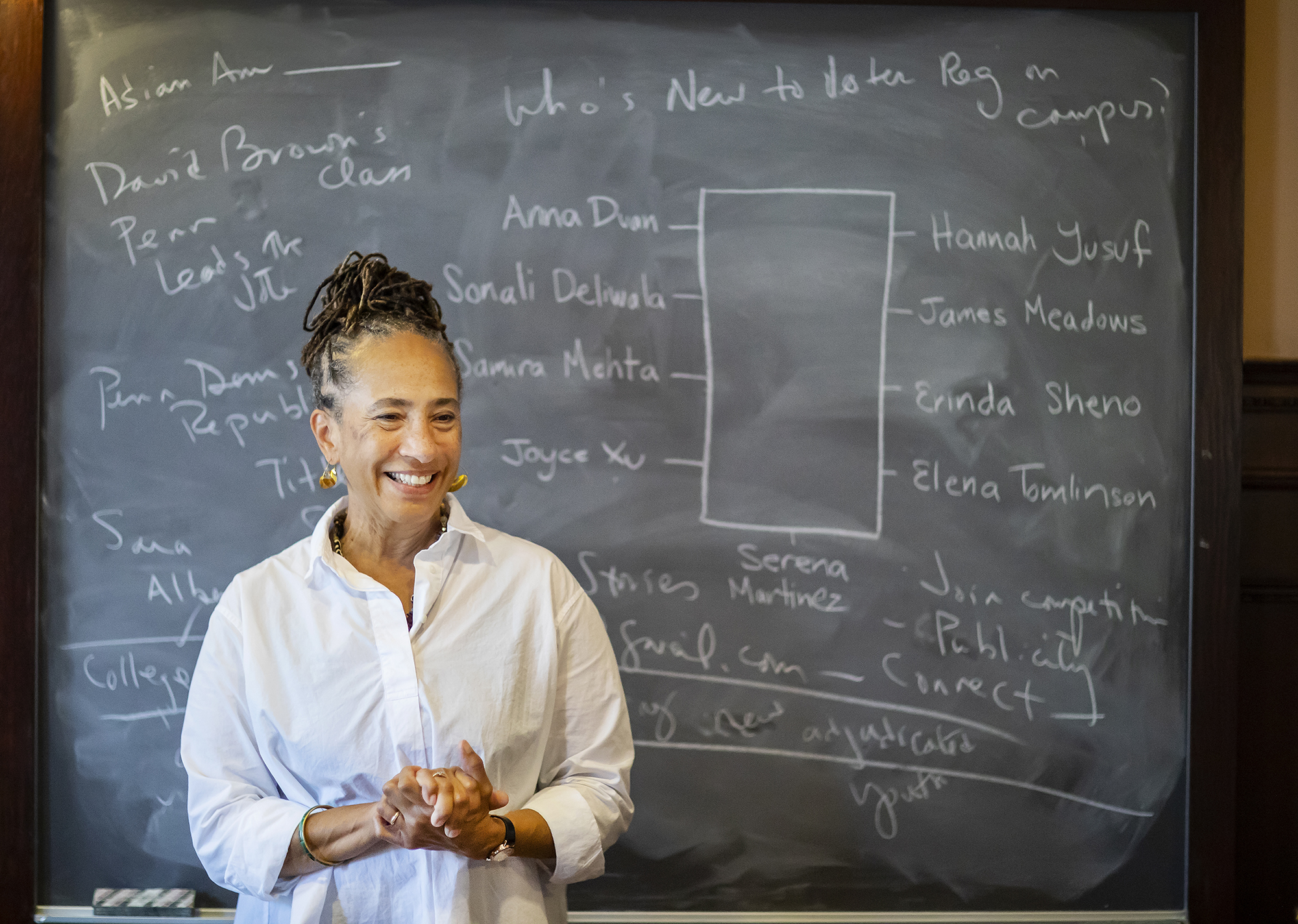 Professor standing in front of a blackboard.