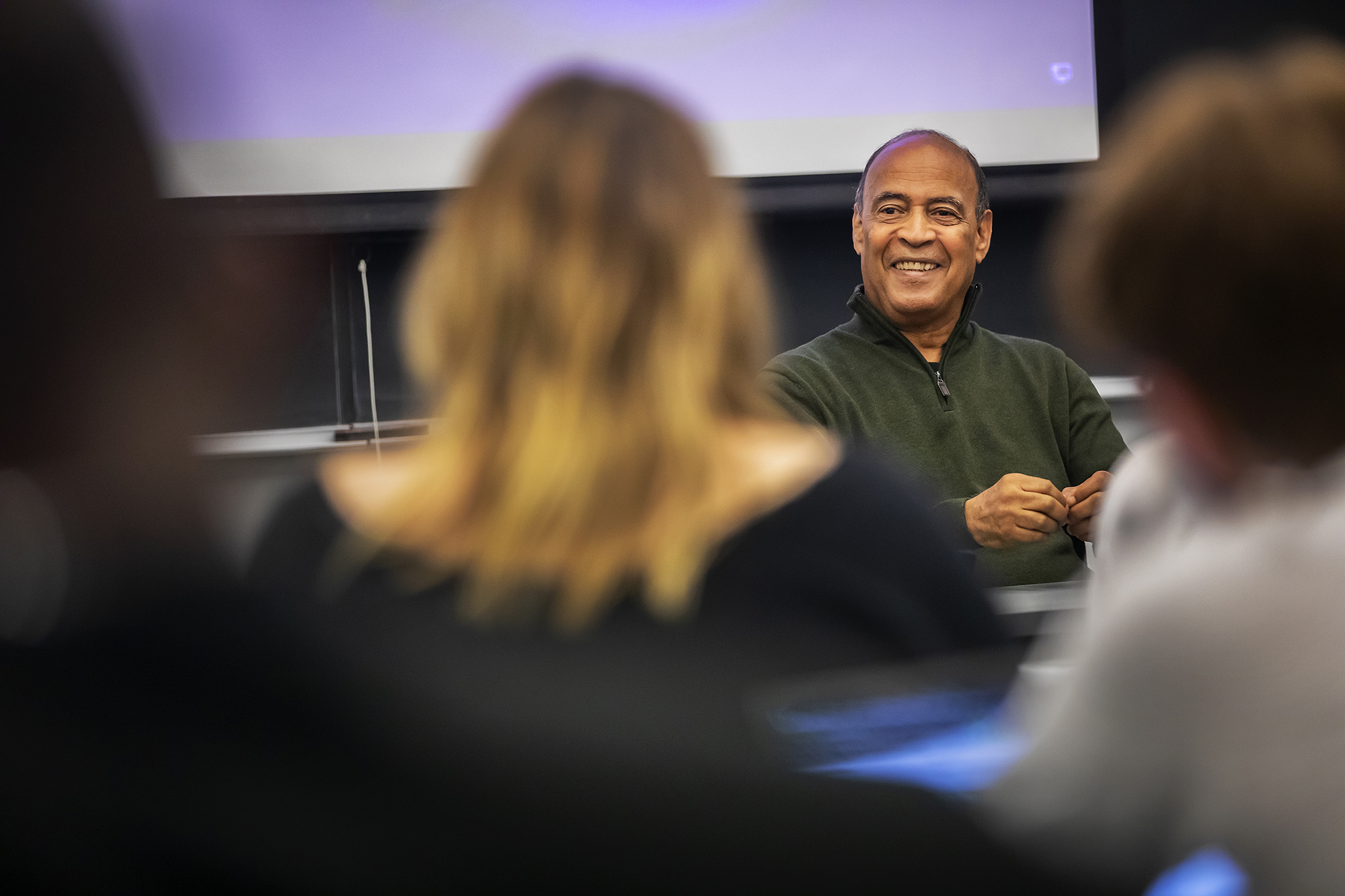 Adolph Reed sitting in front of students