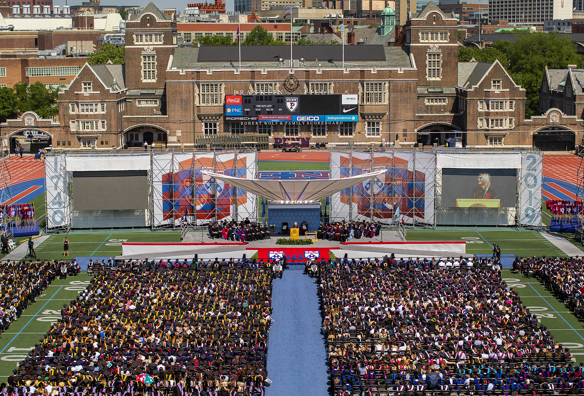 Aerial view of stage and seated graduates.