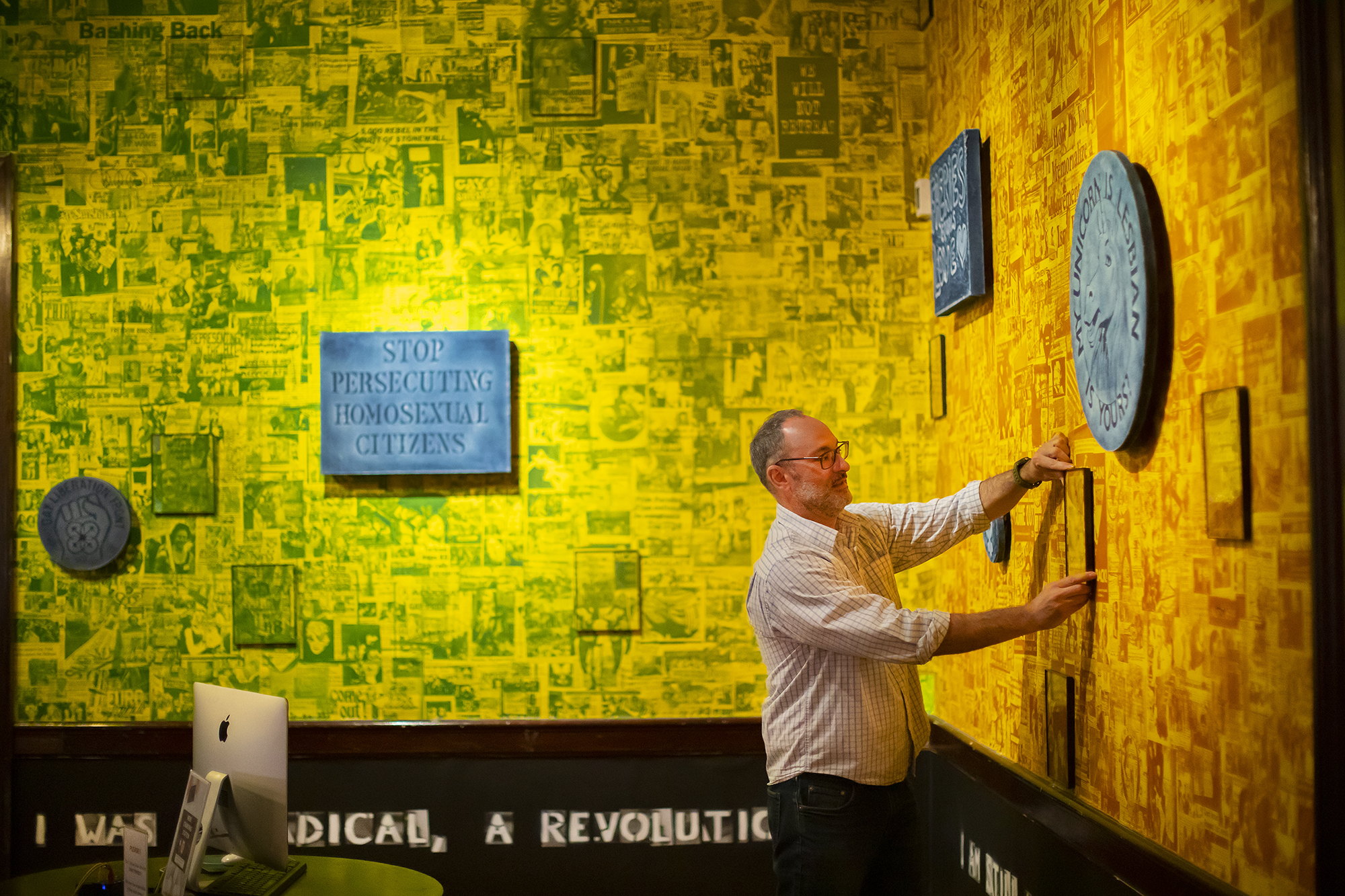 gabe martinez hanging art at stonewall exhibit