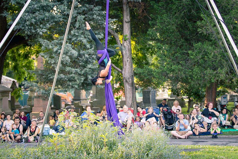 Woman hanging from purple tapestry