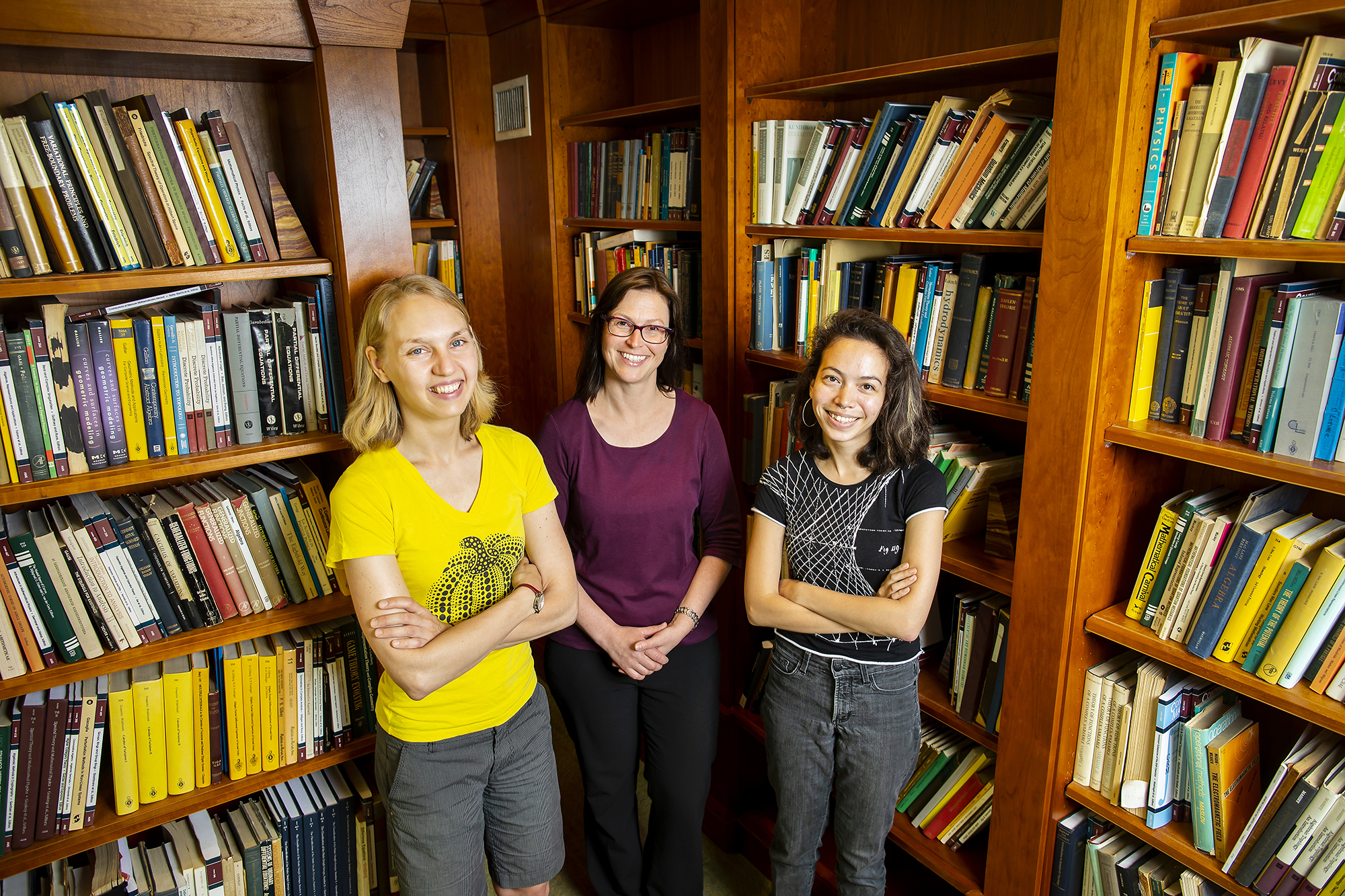 karemaker, hartmann, and bell posing in a library