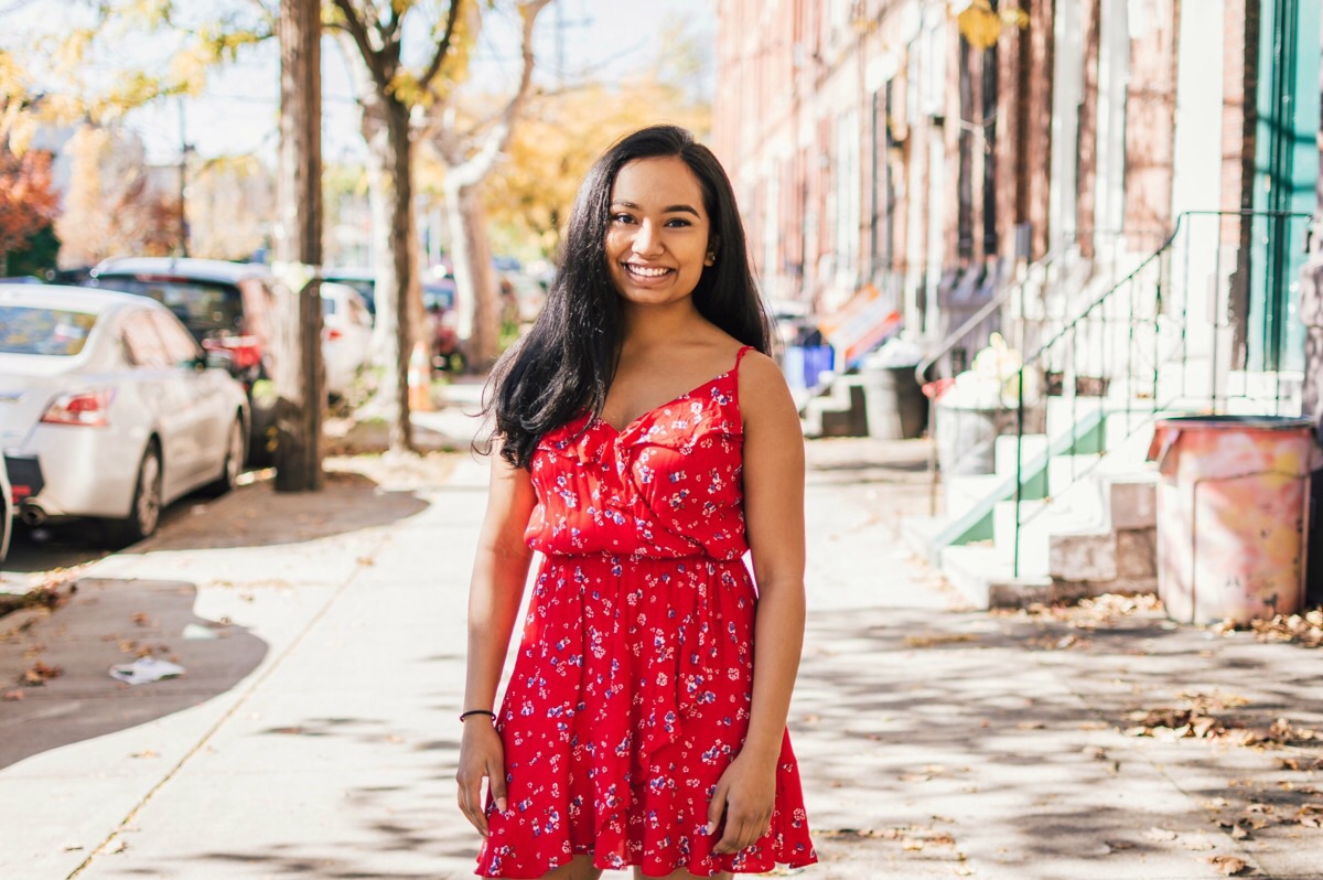 Student standing on a sidewalk.