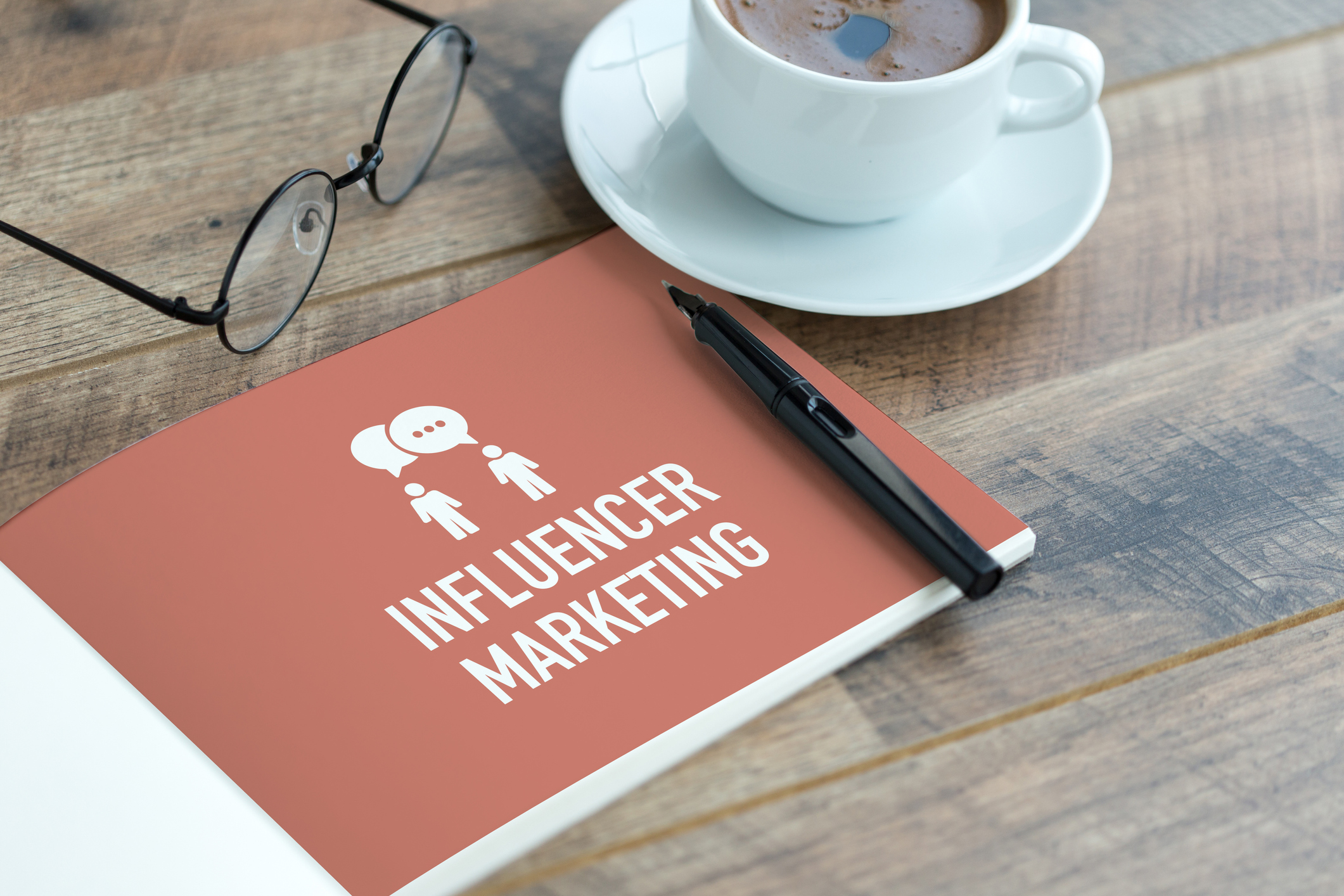 Marketing booklet with pen and coffee