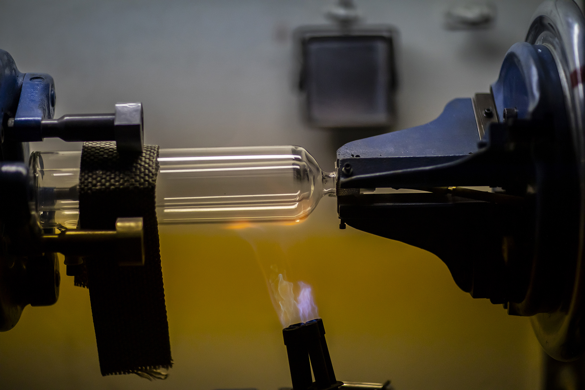 Glass blower forming a chemistry glass, closeup view, glass blower