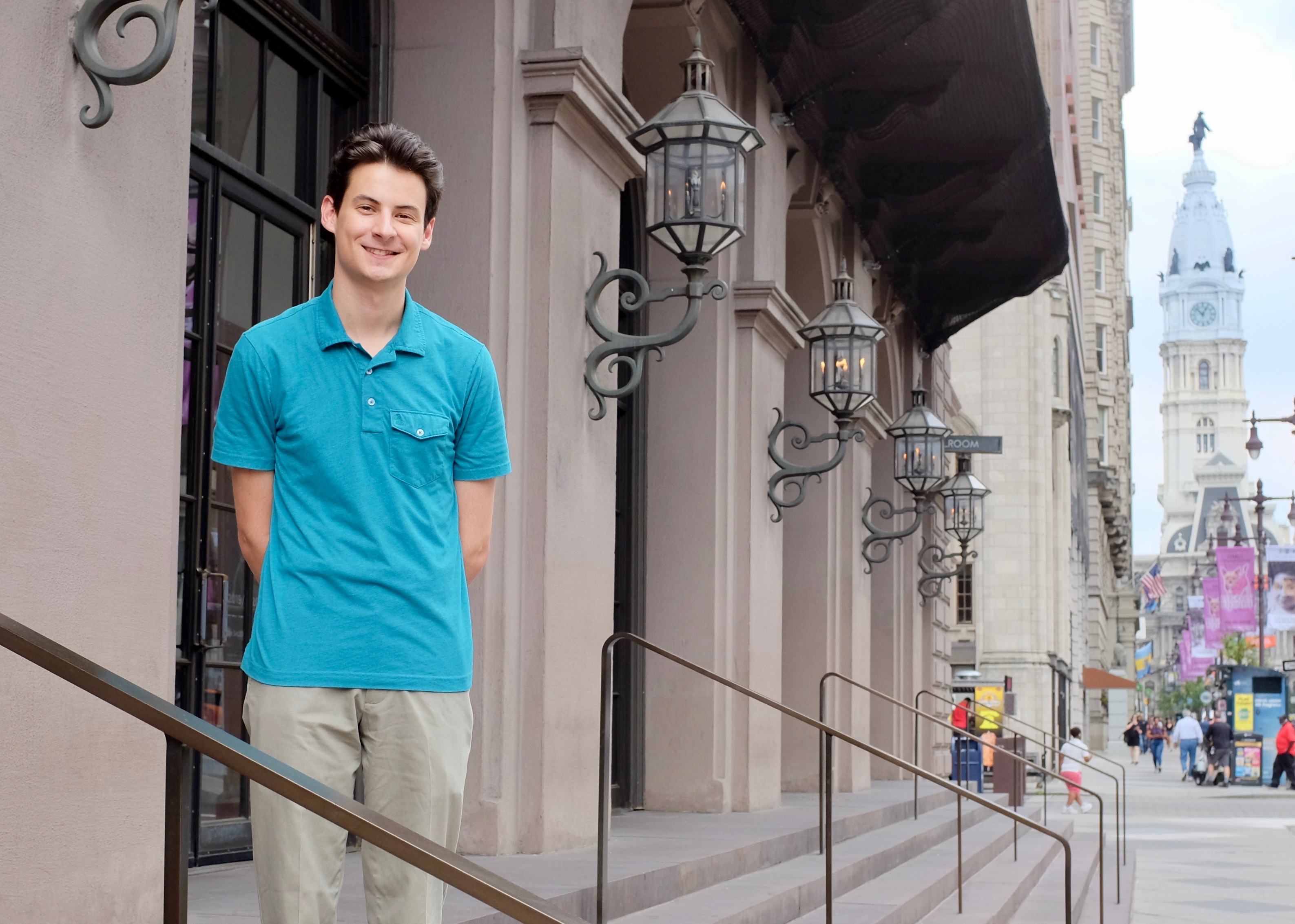 Student standing on steps of the Academy of Music in Philadelphia.