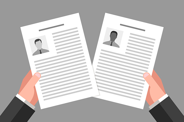 cartoon of two hands holding two resumés, one with a small bio photo of a white person and one with a small bio photo of a black or brown person