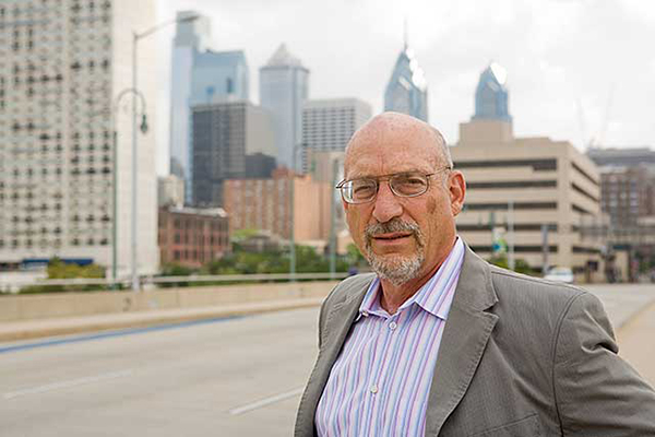 Richard Berk, Penn professor of Criminology and Statistics, on a city street with cityscape in background