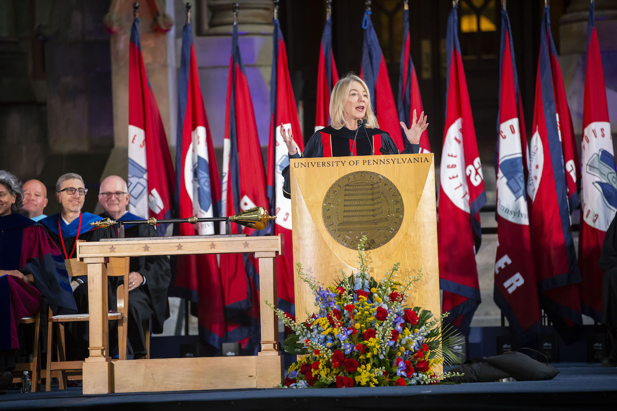 Penn president Amy Gutmann speaks at the podium on stage in front of college hall at convocation 2019