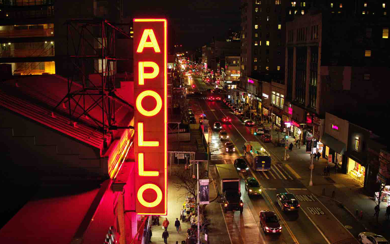 The Apollo sign hangs over bustling New York city street