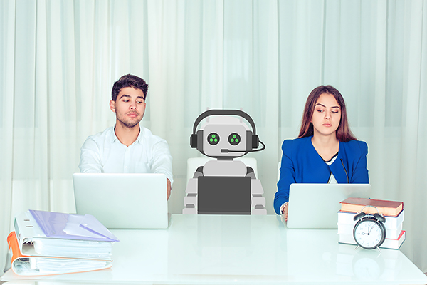 A robot sits between two people at a desk, all with open laptops, the humans eye the robot suspiciously.
