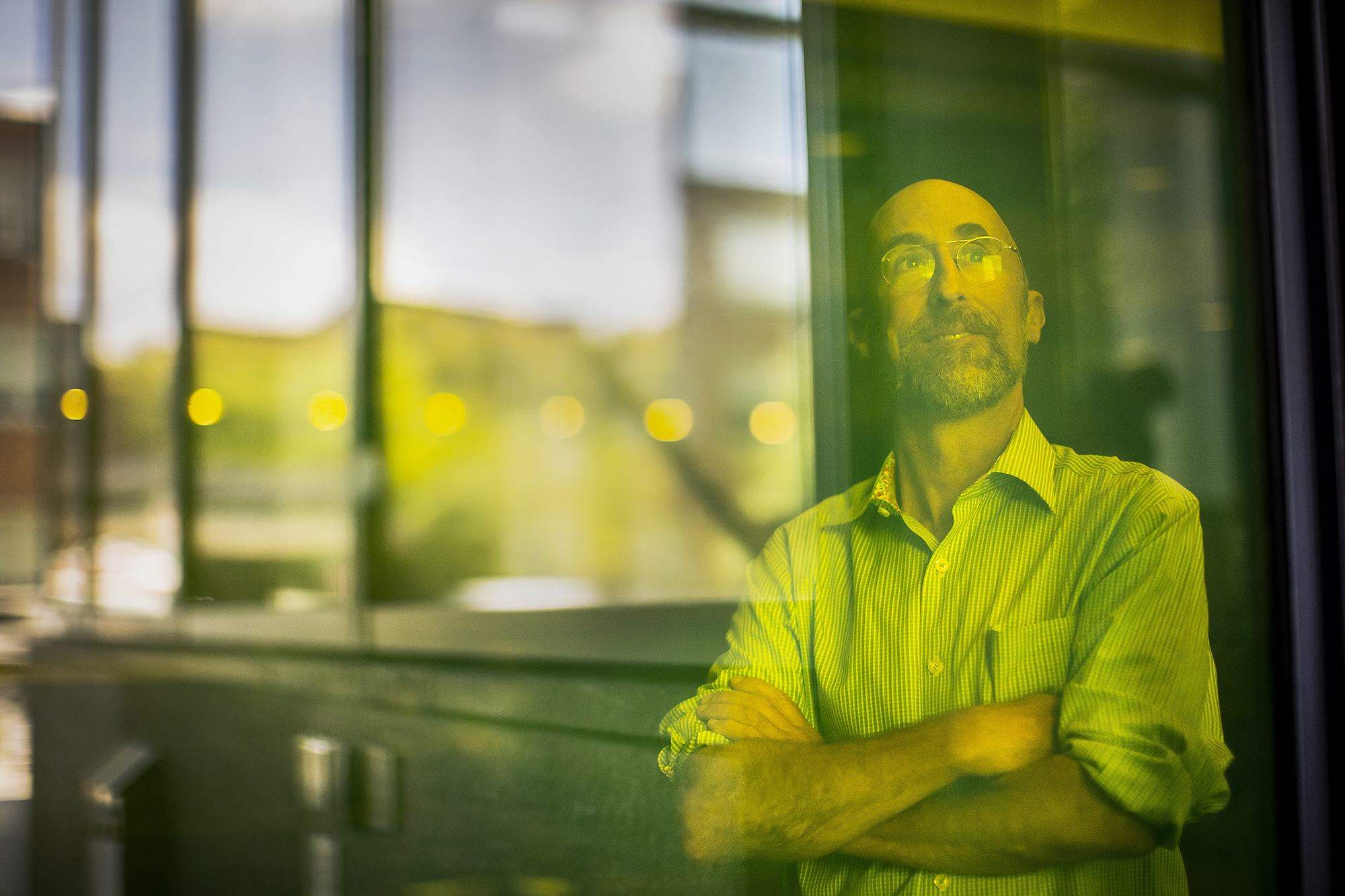 lyle looking out a window with green reflection