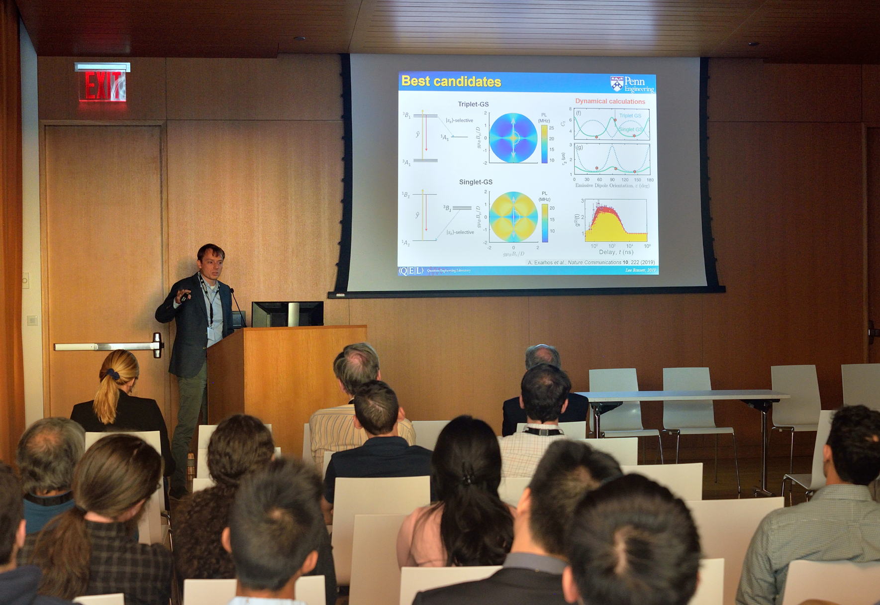 a person giving a scientific presentation in front of a room of people