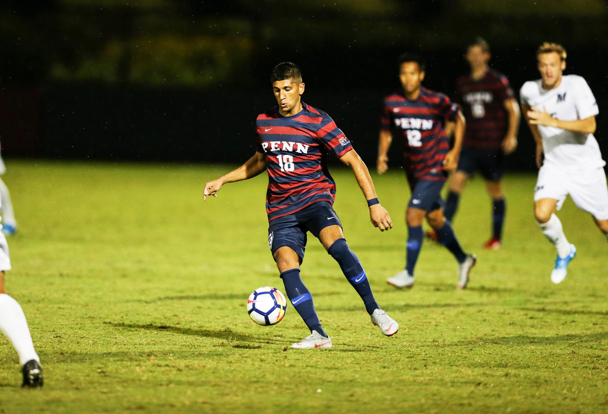 Joey Bhangdia of the men's soccer team prepares to kick the ball.
