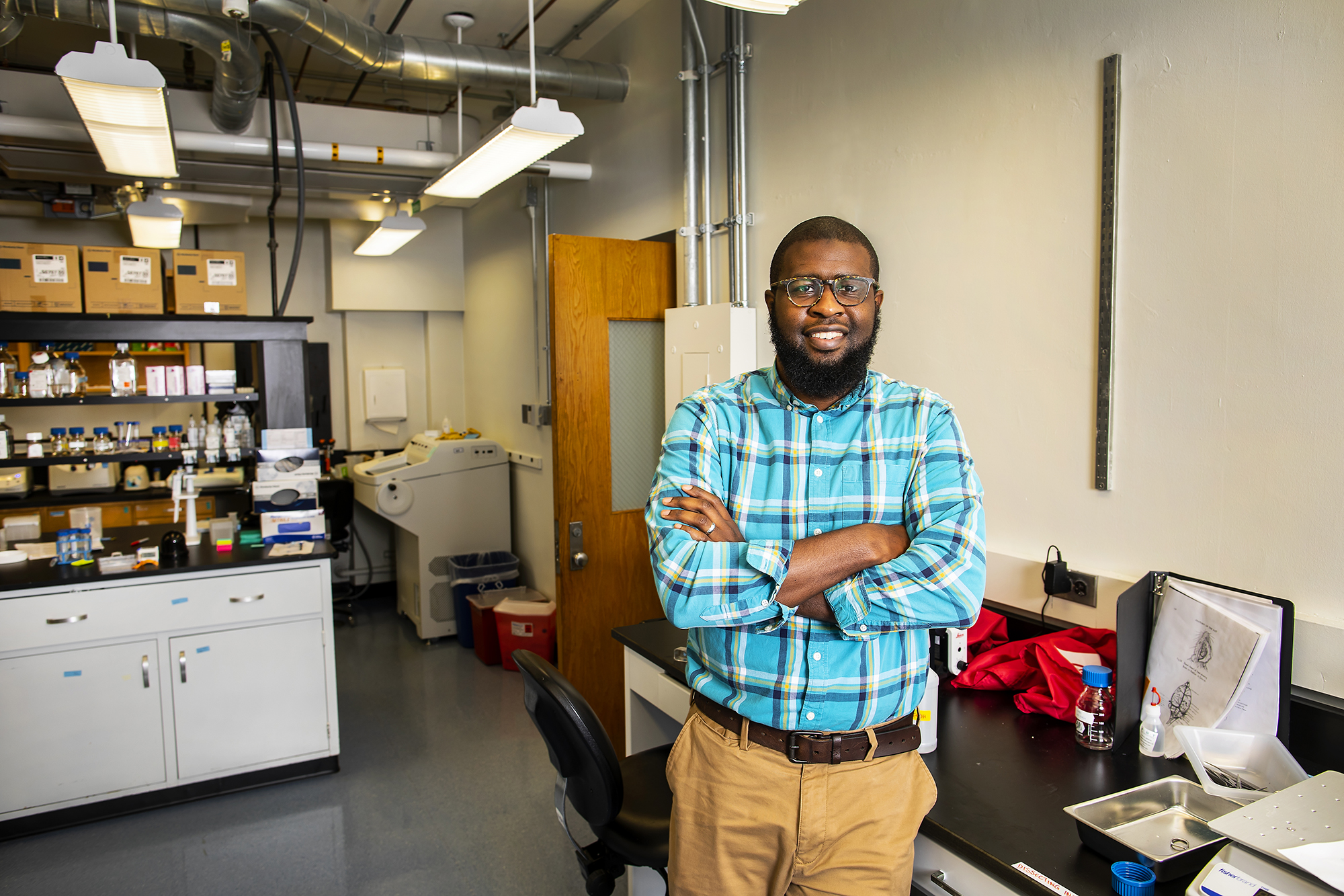 Smiling scientist stands in a lab