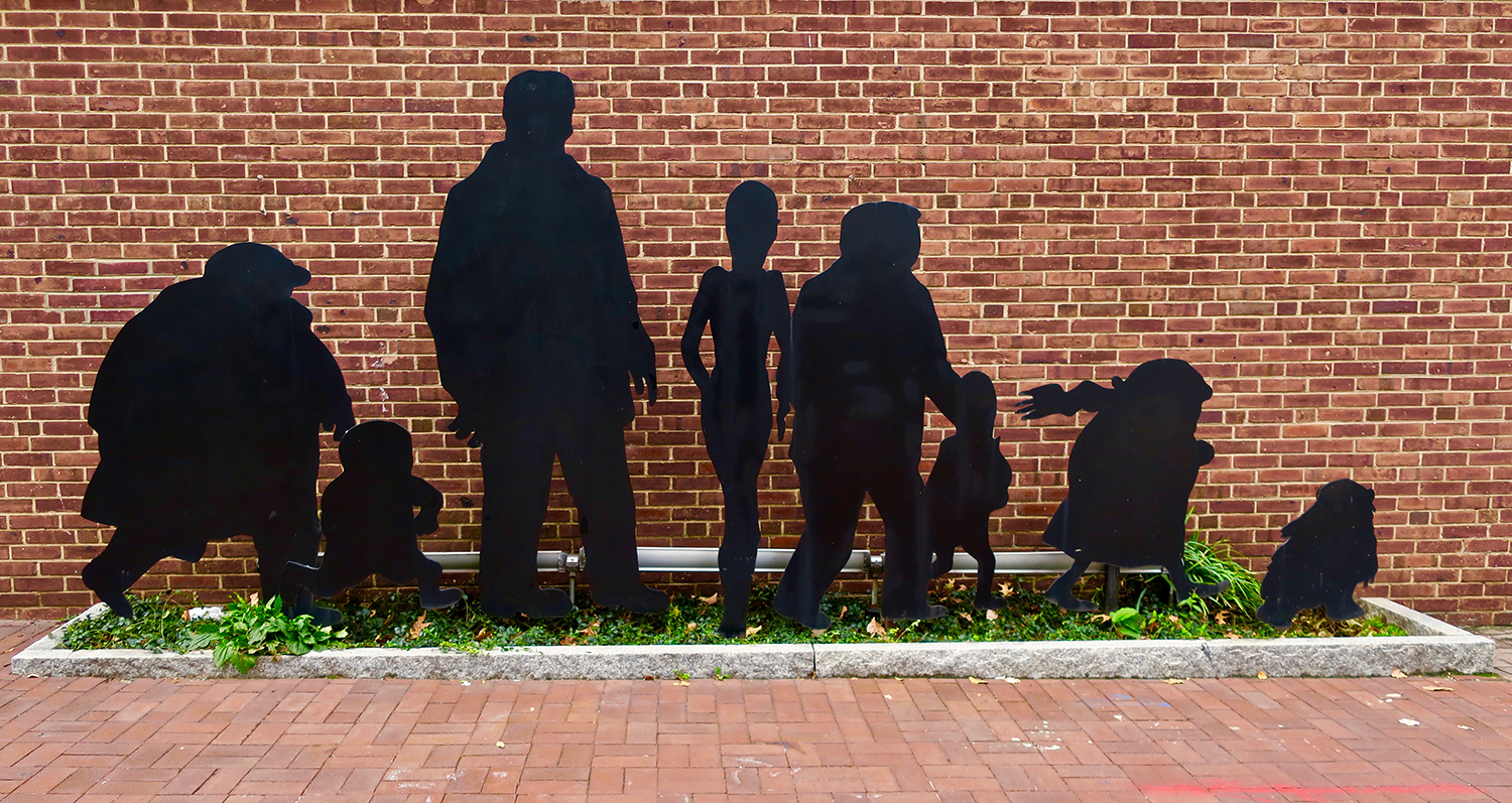 Sculpture of Charles Addams’ Addams Family silhouettes on Penn’s campus.