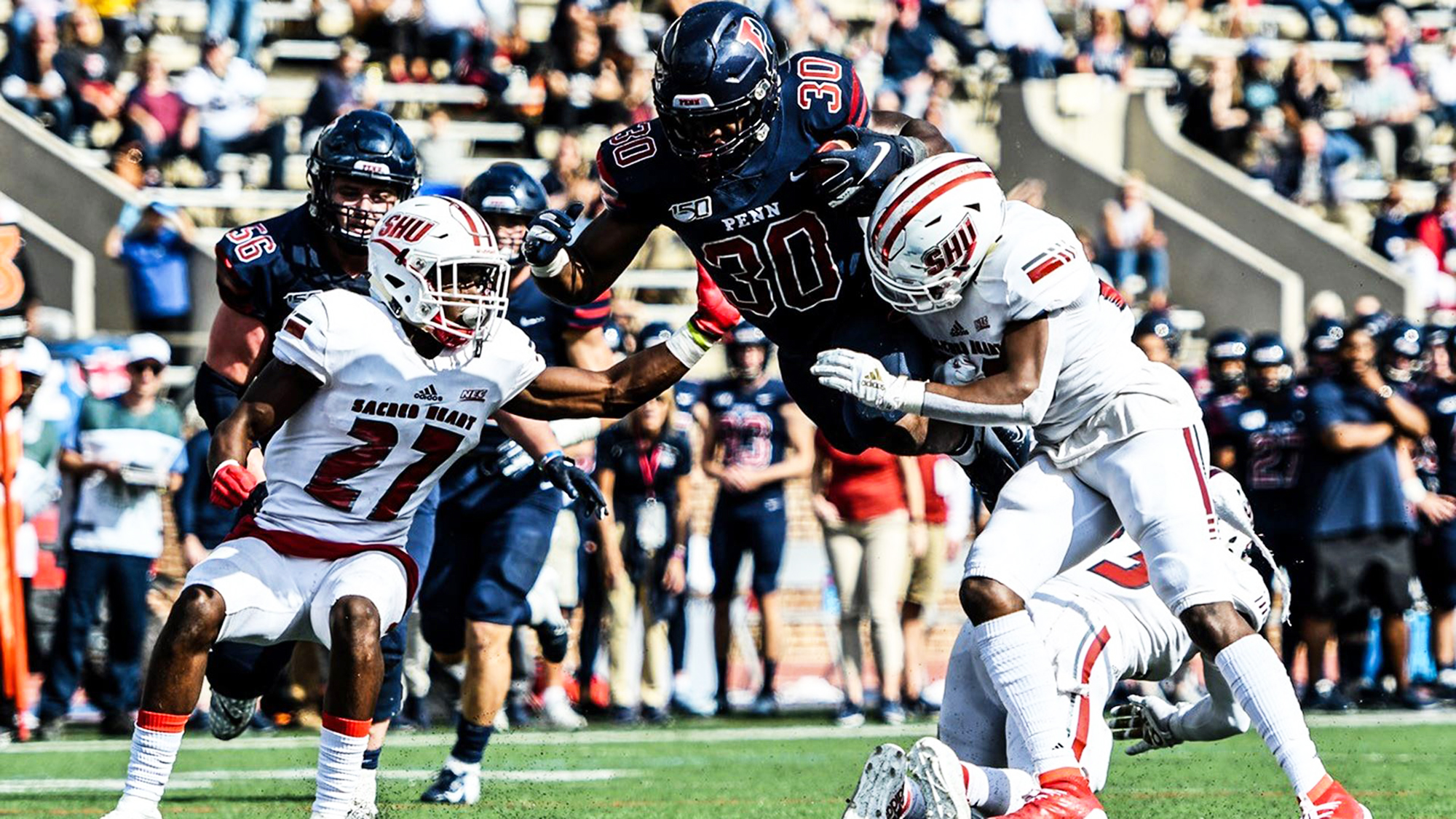 Running back Karekin Brooks leaps into the end zone against Sacred Heart.