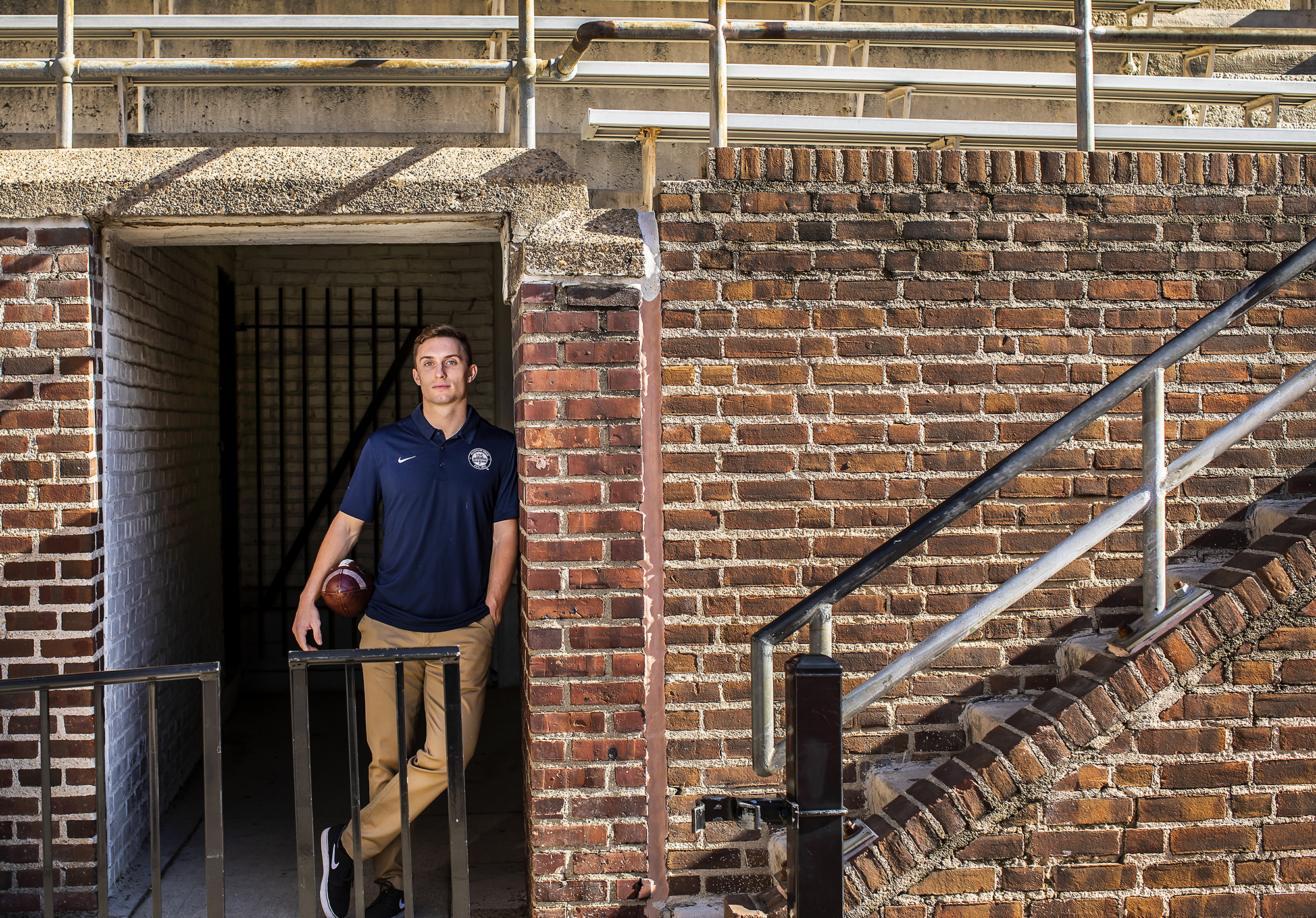 Eddie Jenkins of the sprint football team poses with a football in a tunnel at Franklin Field.