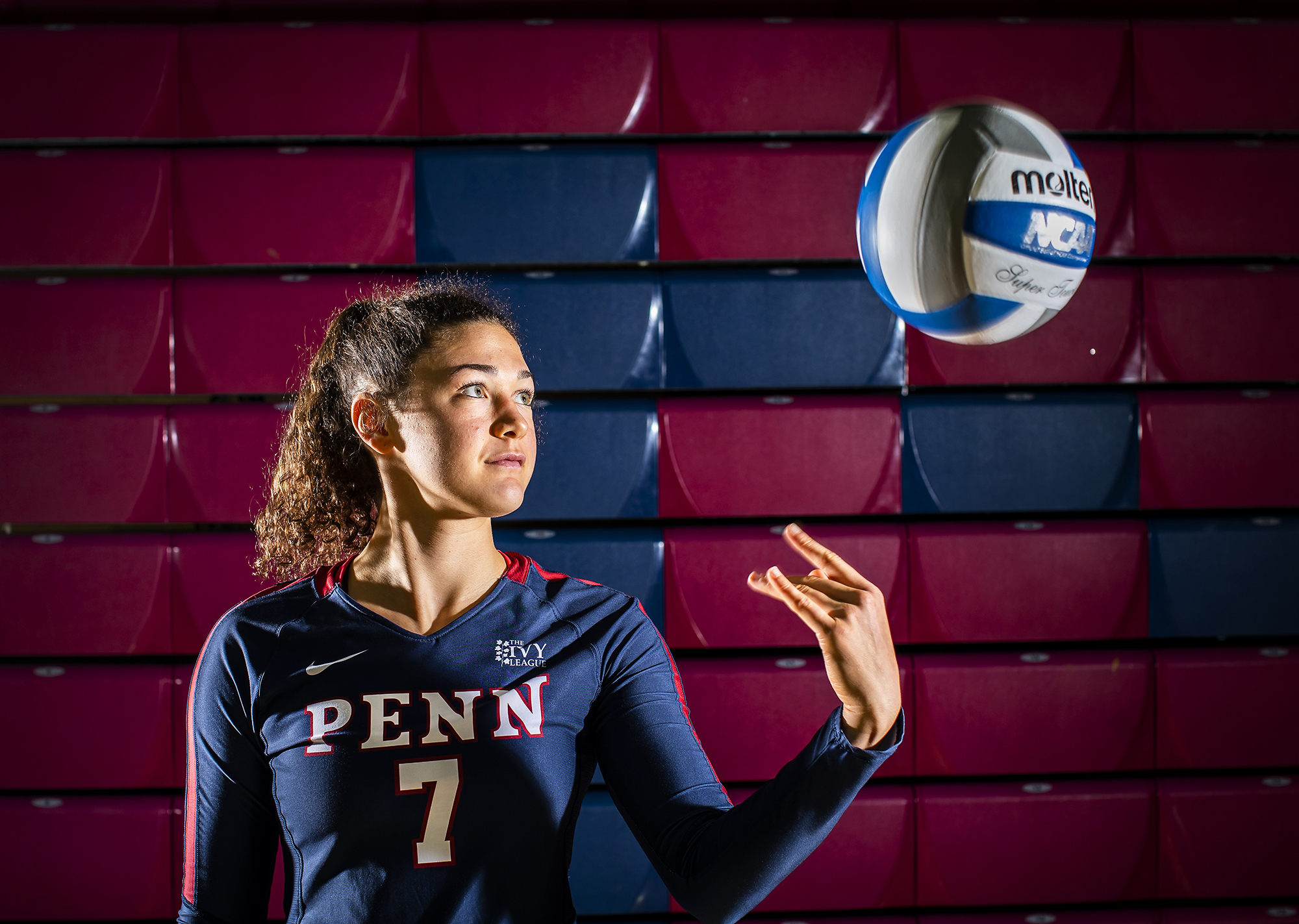 Parker Jones of the volleyball team tosses a ball in the air at the Palestra.