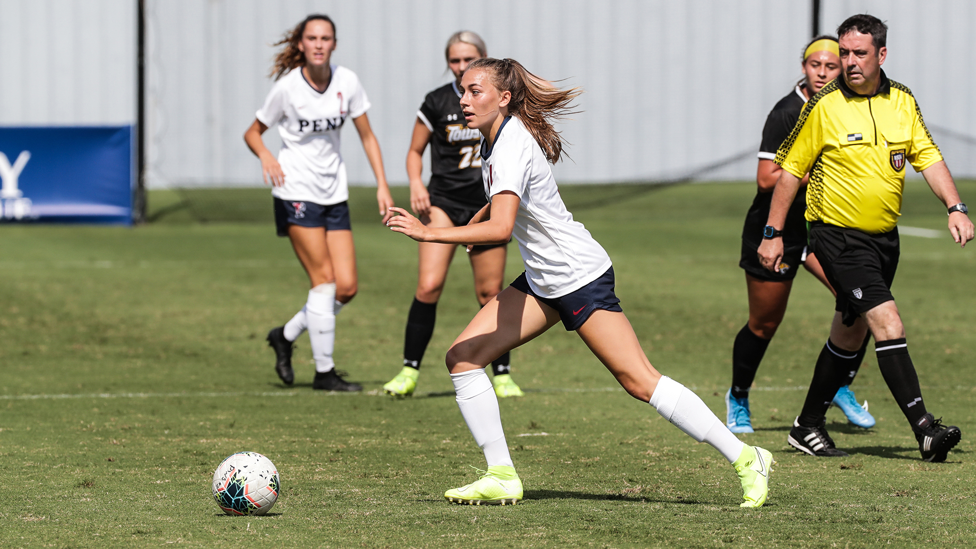 Breukelen Woodard of the women's soccer team dribbles the ball down the field.