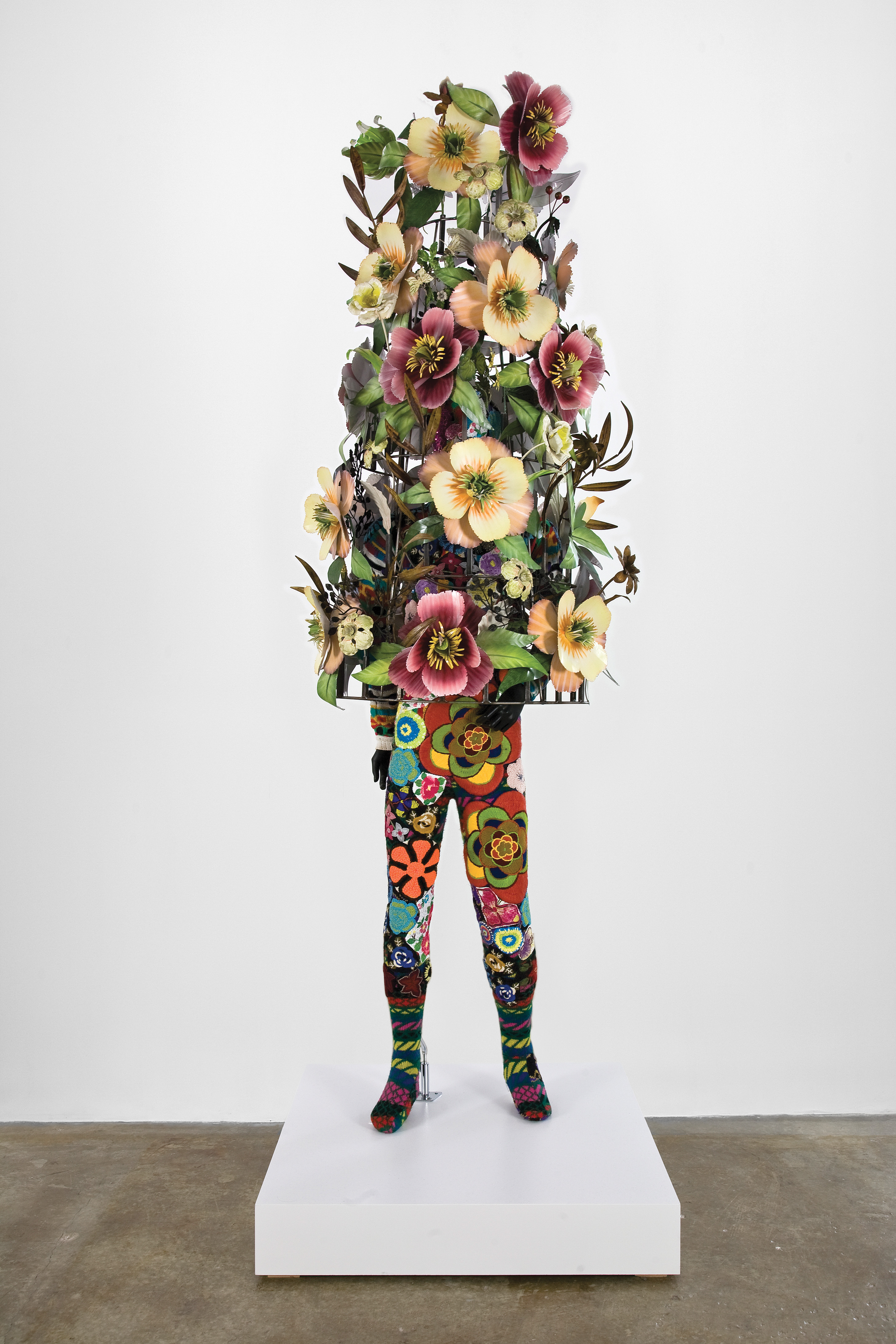 Flowers cover top half of a figure while they wear a floral-patterned pair of tights