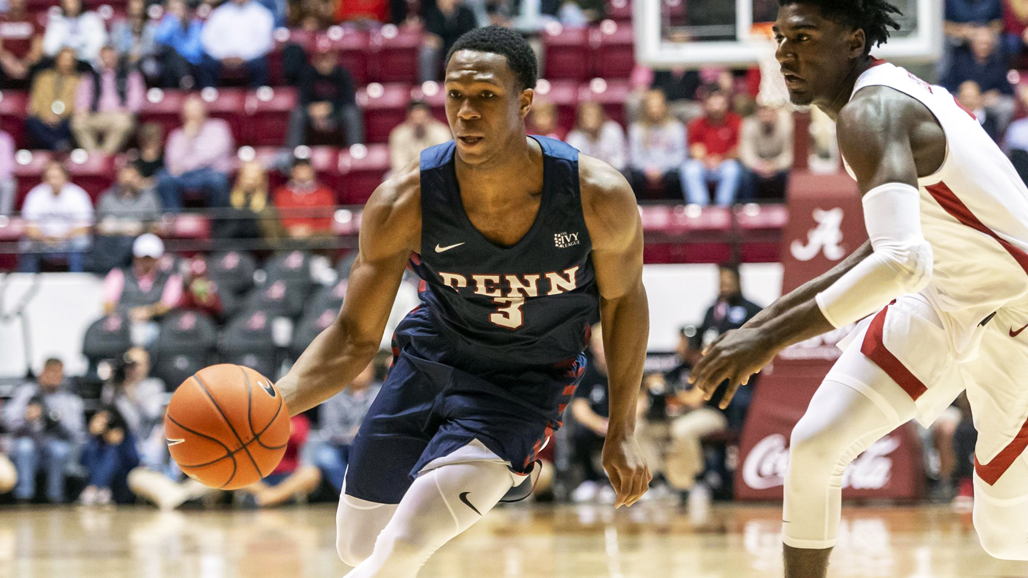 Jordan Dingle of the basketball team drives to the basketball against Alabama.