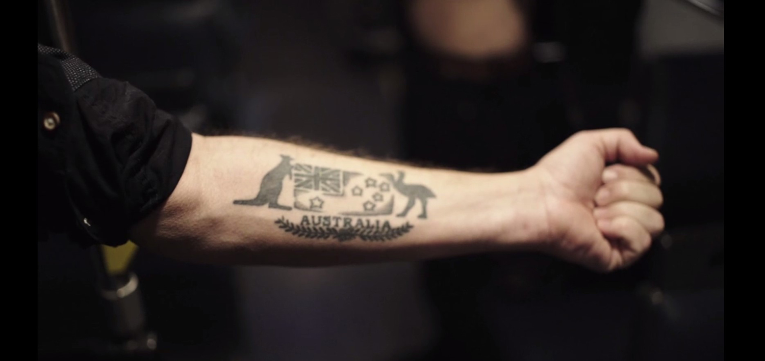 Tattoo that reads Australia, with the Australian flag and kangaroos above it