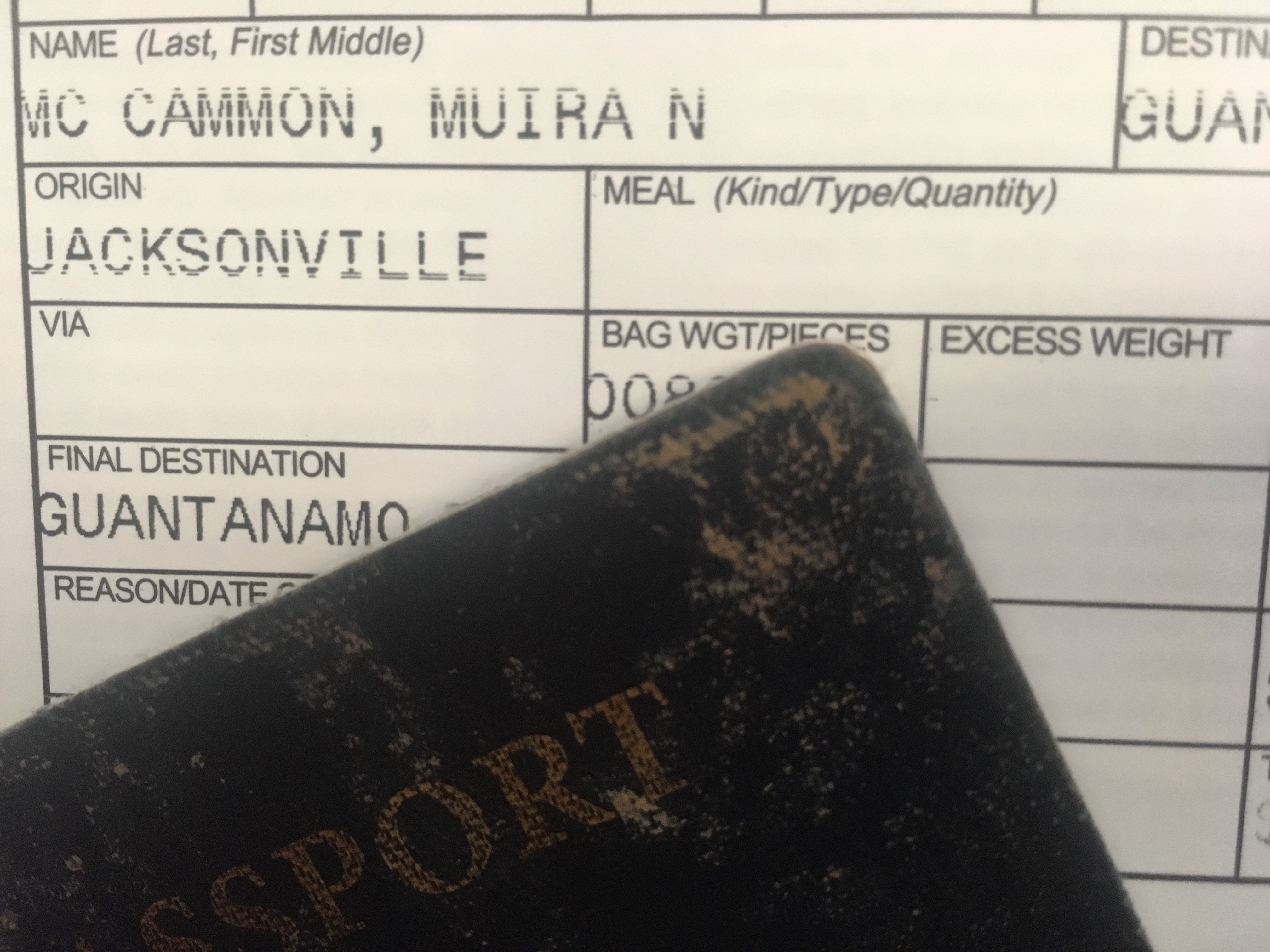 A shot of paperwork that reads, "McCammon, Muira N," "Origin: Jacksonville," "Final Destination: Guantanamo," "Bag Wgt/Pieces," and "Excess Weight." 
