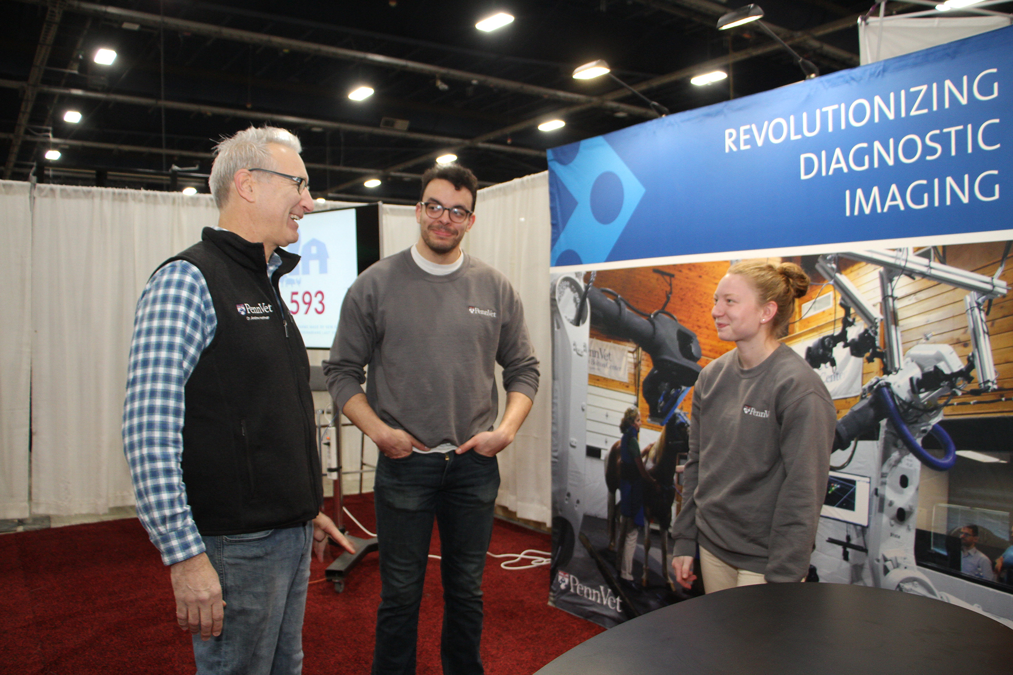 Dean of Penn Vet Medicine Andrew Hoffman talks with Penn Vet students Robert Sander and Kaitlyn Dreese at the Pennsylvania Farm Show