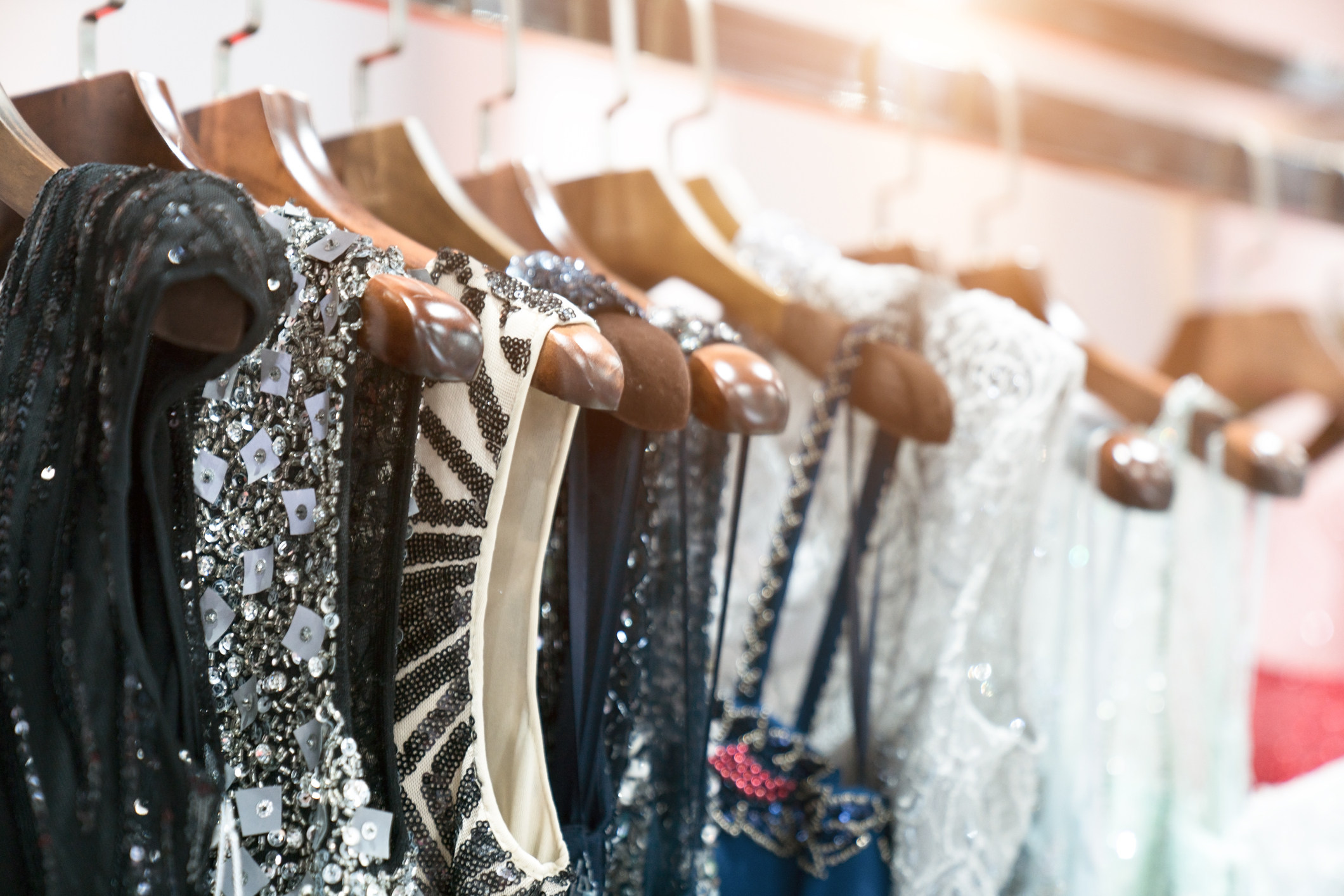 Dresses strung on hangers on a rack.