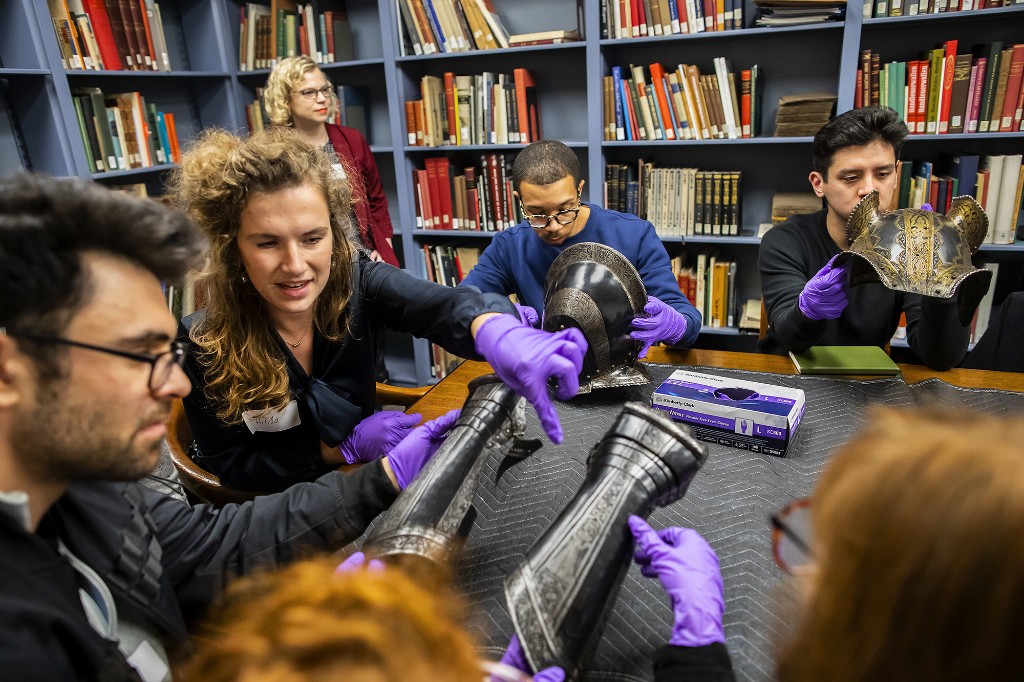 students examine pieces of armor at the pma