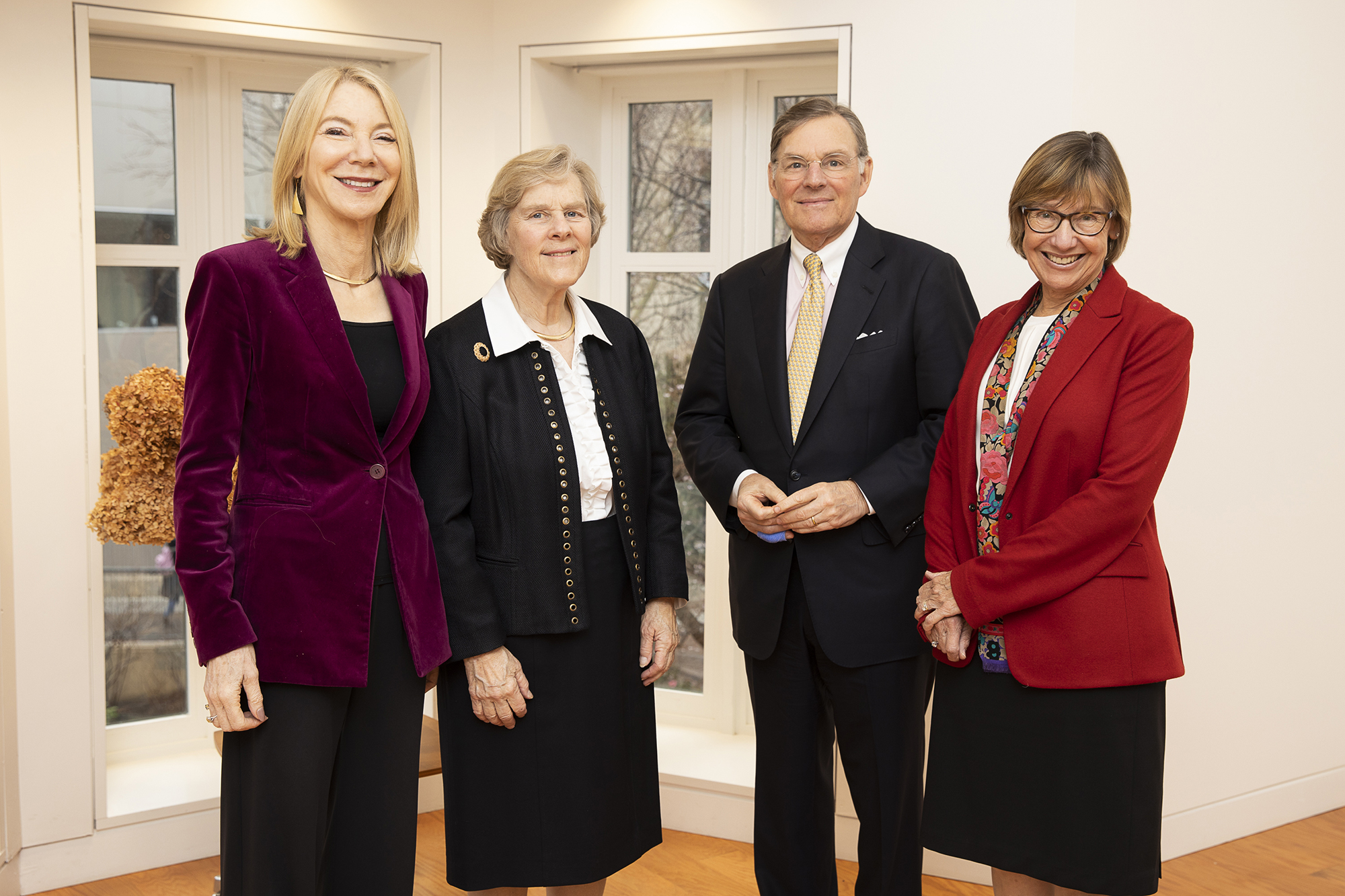 Penn President Amy Gutmann stands with three other people.