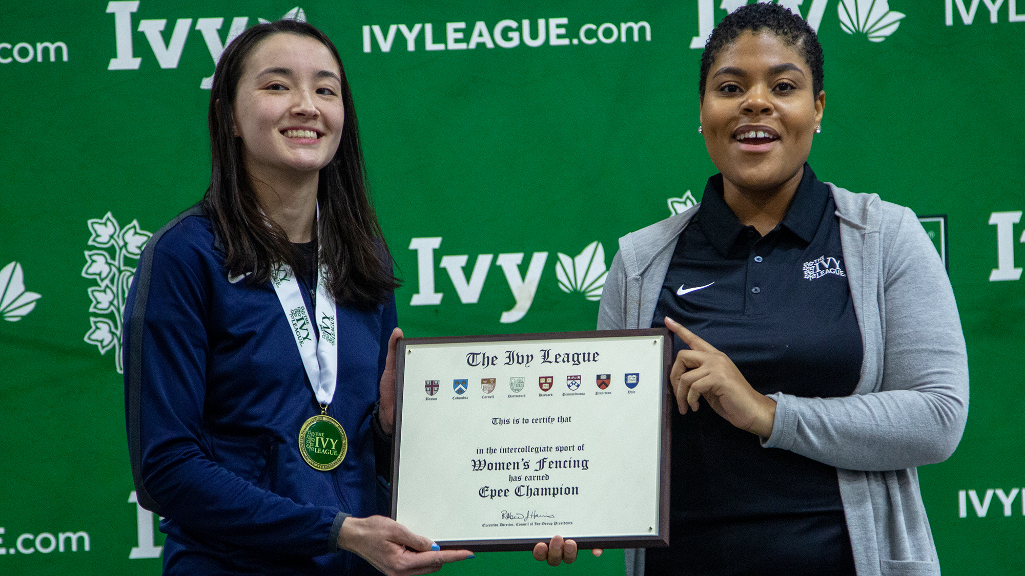 Freshman fencer Chloe Daniel is presented with a plaque celebrating her Ivy epee championship.