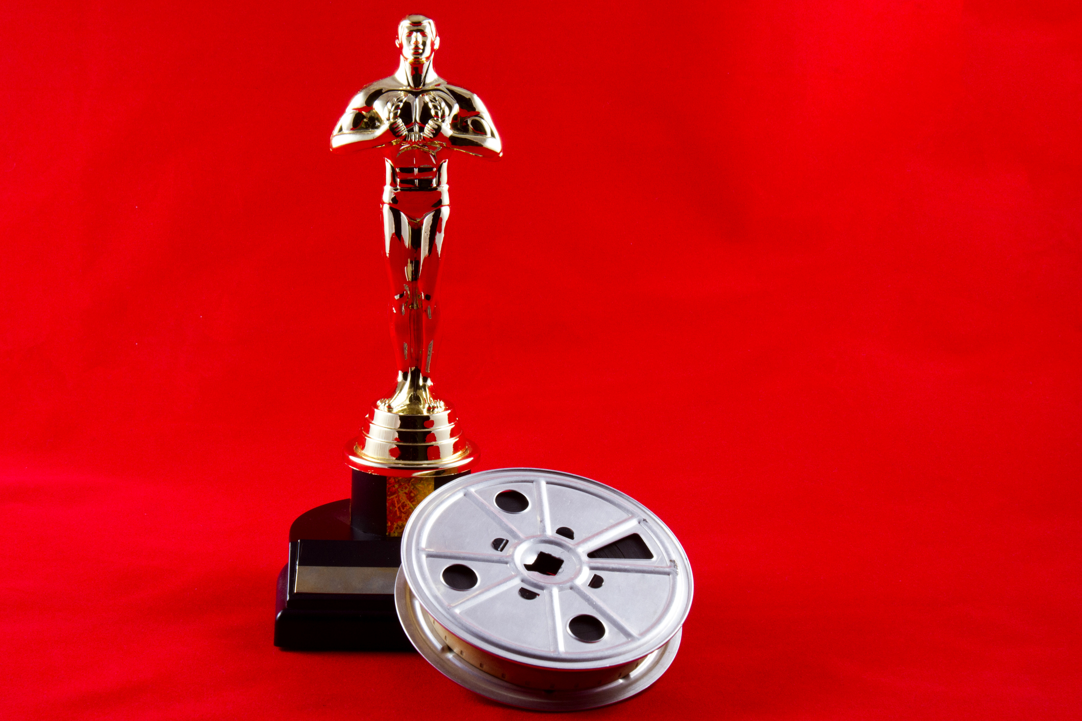 Oscars statue with film reel