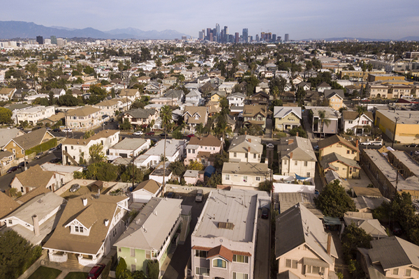 aerial view of suburban housing with LA skyline in background