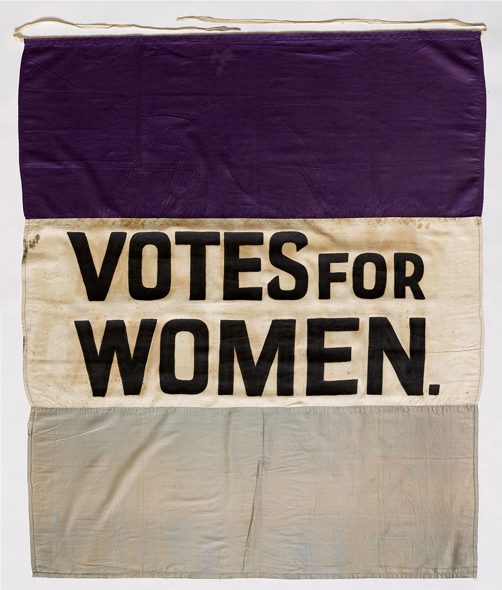 vintage suffrage banner reading VOTES FOR WOMEN.